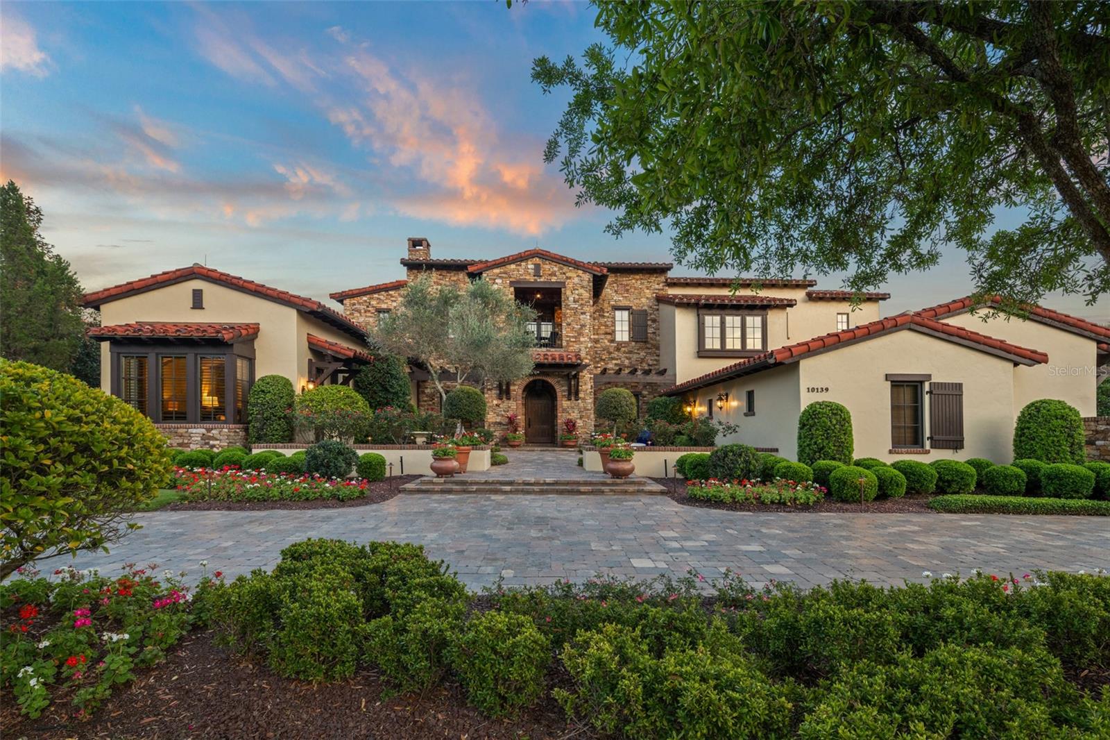 Welcome to an extraordinary sanctuary in the stunning community of Golden Oak, where timeless elegance meets Disney enchantment. Set on over .75 acres, this magnificent estate boasts more than 8,850 sq. ft. of masterfully designed living space—with nearly 7,000 sq. ft. thoughtfully laid out on the main level for effortless living. Nestled on one of Carrolwood’s rare and coveted waterfront lots, this home was created with the utmost privacy in mind. A sweeping governor’s drive sets the stage for a grand arrival, while the secluded backyard offers a private oasis with no neighbors in view. A harmonious blend of indoor and outdoor living, the residence is designed around a sparkling pool and spa, framed by tranquil pond and conservation views. With two outdoor fireplaces, an expansive lanai with motorized screens, and architecture that invites the outdoors in from every angle, this home is truly a 360° vision of comfort and sophistication. Golden Oak residents enjoy access to a private clubhouse and exclusive Disney experiences—while neighboring the Four Seasons Resort Orlando at Walt Disney World Resort, with its world-class golf and dining and luxury spa. This is more than a home. It’s a lifestyle infused with magic.
