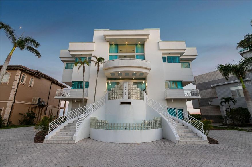 Located in the private, gated enclave of Esplanade on the Bay, this one of a kind contemporary bay front home has been masterfully designed. Every room is an experience in luxury living, featuring a seamless blend of indoor and outdoor spaces with endless water views.
Spanning over 6728 Sq. Ft., exquisite stone floors and curated lighting adorn this 4 bedroom, 5 1/2 bath residence. The stately great room with it's soaring ceilings and wall to wall glass windows is the focal point of the main level, accompanied by an elegant formal dining room, gourmet chief's kitchen with top tiered appliances and oversized island. The spacious owners suite features a fireplace and spa-like bathroom retreat. The second floor has a large family room, study, home theater, guest room and two additional bedrooms with en-suite baths.
Outdoors, enjoy the sparkling pool and spa, and expansive terraces offering multiple seating areas, alfresco dining, and stunning panoramic views of Sarasota Bay. Additional features include solar energy, oversiized 4 car garage, catering kitchen, billiard room, elevator, meditation room and so much more.
This extrodinary home offers unmatched sophisticaion and comfort for luxury living, all within easy access to downtown Sarasota, fine dining and barrier islands and only 1 Mile to IMG Academy and 10 Minutes to Sarasota-Bradenton Airport.