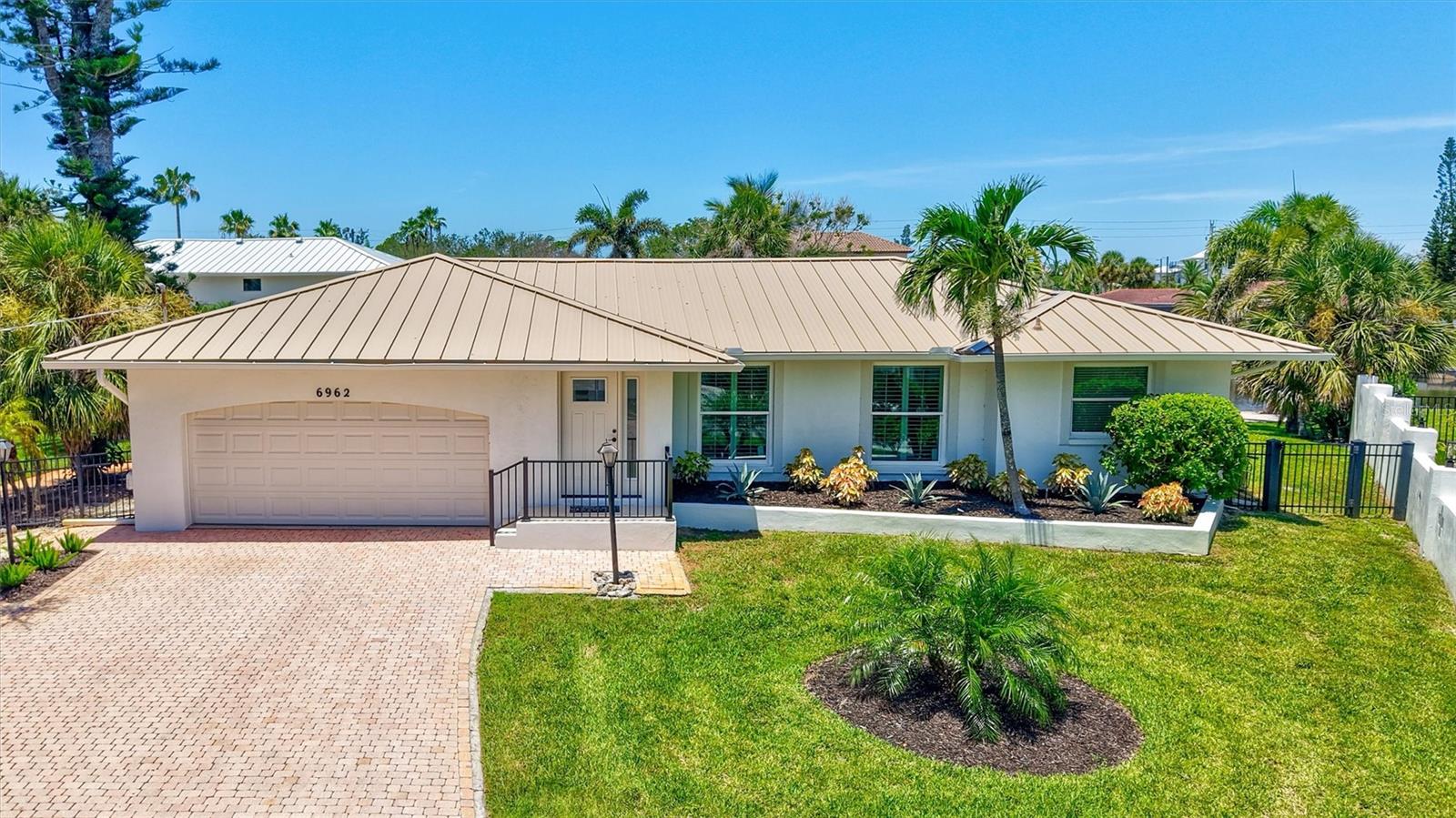 FABULOUS Siesta Key property on protected canal with direct Intracoastal and Little Sarasota Bay access. The star of this property is the protected canal with cement seawall and dock just 5 homes from the Intracoastal Waterway. Easy Gulf access via newly opened Midnight Pass allows expanded boating options. The 0.39 acre lot has plenty of room to expand the current home if desired. The location can’t be beat: less than 1 mile to the Stickney Point Bridge. 0.4 miles to Siesta Key Beach Access #13. Only 4 blocks to dining, shopping and entertainment. This home is on a quiet, private cul-de-sac. Move right in, remodel, or build you dream home. The fenced yard is perfect for family and pets. A new metal Roof was added in 2025 and a new AC in May 2024. The 2020/2021 remodel extended and updated the kitchen, enclosed the rear lanai, relocated the front door to add an interior foyer, and upgrade most windows and sliders. The kitchen expansion included new cabinets and an oversized breakfast bar. This split-plan home has a large primary bedroom with French doors opening to the pool. On the other side of the home find a guest bedroom, updated full pool bath, and secondary suite with a half bath (with plenty of room to create a full bath) that also opens to the pool. The current office can be utilized as a 4th bedroom with closet and ramp directly to the garage. With a separate living room and family room, there is plenty of space for everyone to spread out. Outside, find a large pool area overlooking the canal and a large, circular driveway that has beautiful pavers and two large side yards. This home experienced NO flooding during the 2024 storm season. Best of all, the Seller is offering their beloved 1966 Dodge Dart V-8 GT Convertible with a full-priced offer.