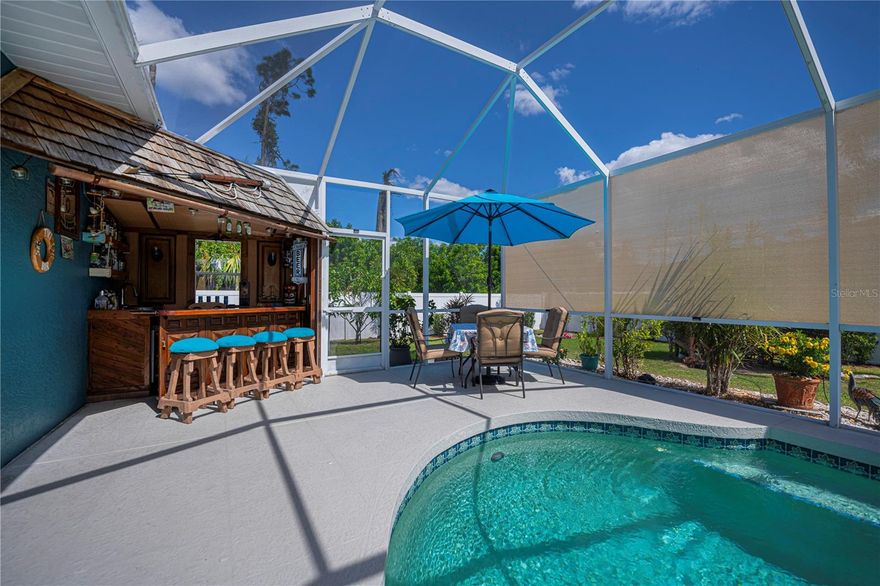 Prepare to be WOWED by this ABSOLUTELY STUNNING 3-bedroom, 2-bathroom, 2-car garage POOL HOME in North Port! The ultimate backyard SHOWSTOPPER awaits you—a one-of-a-kind POOLSIDE TIKI BAR that’s perfect for unforgettable parties and fun-filled weekends with friends and family!

This beautifully updated home not only screams style but also delivers AMAZING SOLAR SAVINGS, along with custom decorator touches throughout that make it truly one of a kind.

 PRICE IMPROVEMENT ALERT! 

Step inside through a warm and inviting entryway to discover elegant ceramic plank tile flooring, rounded corners, and stunning sunburst windows that flood the space with natural light—all within a fully fenced private yard for your ultimate peace and privacy.

CALLING ALL CHEFS! The gourmet kitchen is a dream come true featuring pristine white shaker cabinets with soft-close doors and drawers, a trendy subway tile backsplash, gorgeous granite countertops, a massive pantry, and a convenient island with top-of-the-line appliances ready for your culinary creations.

The expansive living room and separate dining area, enhanced with stylish custom accents, create the perfect setting for entertaining and making memories with loved ones.

Your luxurious master suite is a true retreat, with private patio and pool access, a spacious walk-in closet, and a beautifully updated ensuite boasting dual sinks, granite vanities, and a private commode. Guest bedrooms are generously sized and share a modern, beautifully updated bathroom.

Step outside to your oversized, sparkling private pool surrounded by a generous sundeck ideal for soaking up the sun, a large covered patio for shaded relaxation, and that jaw-dropping custom tiki-style outdoor wet bar—this backyard is truly an entertainer’s paradise! Garden enthusiasts will fall in love with the pergola misting system, designed to nurture orchids and create a peaceful outdoor oasis.

Additional standout features include:

*New 2023 no-see-um screening and modern ceiling fans
*Brand new 2025 A/C system
*Recent property survey for your peace of mind
*Public water & septic (2013)
*Smart 8-zone sprinkler system with Bluetooth technology (2020)
*Inside laundry with extra storage cabinetry
*Miami-Dade Kevlar hurricane protection
*29 solar panels delivering instant solar equity with an assumable lease of 18 panels at $130/month and an estimated electric bill of only $30 for buyers after sellers pay off the remaining owned ones at closing!
*Garage with sliding screened doors for airflow and privacy
*8x10 outdoor shed with electricity and water—perfect for hobbies or extra storage
*No HOA fees and no flood insurance required!
Perfectly located near Myakka State Park and Myakkahatchee Creek Environmental Center with miles of trails, horseback riding, hiking, birdwatching, and water access. Plus, you’re just minutes from Punta Gorda Airport, shopping, dining, stunning beaches, Warm Mineral Springs, and the aquatic center.

This SOLAR-POWERED PARADISE blends luxury, comfort, and INCREDIBLE SAVINGS all in one incredible package—your PERFECT PRIVATE RESORT home is waiting in North Port!

DON’T WAIT—schedule your visit today before this fabulous tiki graced pool home with solar savings is gone!