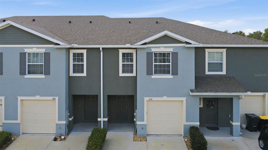 Welcome to 1292 Yellow Finch Drive, Davenport, FL, located in the desirable Atria at Ridgewood Lakes community. This beautiful 2022-built townhome offers 3 bedrooms, 2.5 bathrooms, and approximately 1,700+ square feet of living space, combining modern design with comfort and convenience. Step inside to an open-concept floor plan featuring spacious living and dining areas—perfect for everyday living and entertaining. The modern kitchen flows seamlessly into the main living space, creating an inviting atmosphere for family gatherings. Upstairs, you’ll find generously sized bedrooms including a comfortable primary suite, while durable vinyl flooring throughout the staircase and second floor adds both style and easy maintenance. Enjoy Florida living on your private screened patio with a motorized retractable screen, ideal for relaxing outdoors while staying protected from the sun and insects. Conveniently located just minutes from US-27, I-4, shopping, dining, schools, and Central Florida attractions, this home offers the perfect balance of tranquility and accessibility. Don’t miss this opportunity to own a beautiful, move-in-ready home in one of Davenport’s growing communities—schedule your private showing today!