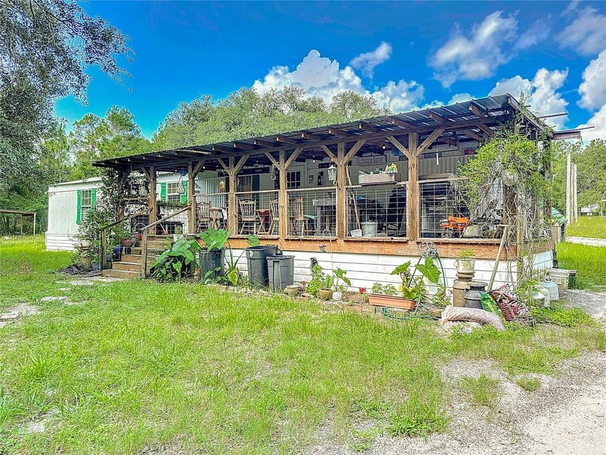 One or more photo(s) has been virtually staged. Bring all your toys and enjoy the space! This 2-bedroom, 2-bath split-floorplan mobile home sits on 5.3 acres in peaceful Keystone Heights, with an enormous front porch overlooking mature oaks. Featuring a large detached garage perfect for RVs, four-wheelers, dirt bikes, tools, and more. The home has a newer roof, updated plumbing and electric, new windows, and a spacious kitchen with an island. There's plenty of room for a garden, fruit trees, or even a future pool. With a little TLC inside, this home could be your perfect country retreat. No HOA—just land, space, and freedom! Schedule your private showing today before it's gone!!