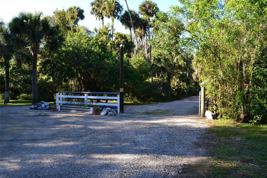 Beautiful Parcel of Land that has its own gated entry.   Property abuts the Sugar Mill Golf Course and Tara Trails.   This  hammock with mammoth size oak trees that are hundreds of years old and add beauty to this land.  This beautiful parcel of old Florida has a small creek that runs along the south side of the property.  A  Survey and set backs for creek and wetland area has already been delineated by Biological Consulting Services, Inc.  A wetland easement has been established and the site is ready for your new home.   Location of the home site is partially cleared .  Location is short distance to the city ball parks, Turnbull Creek and short drive to the beach and shopping.; Cleared: Partial ;Water: City