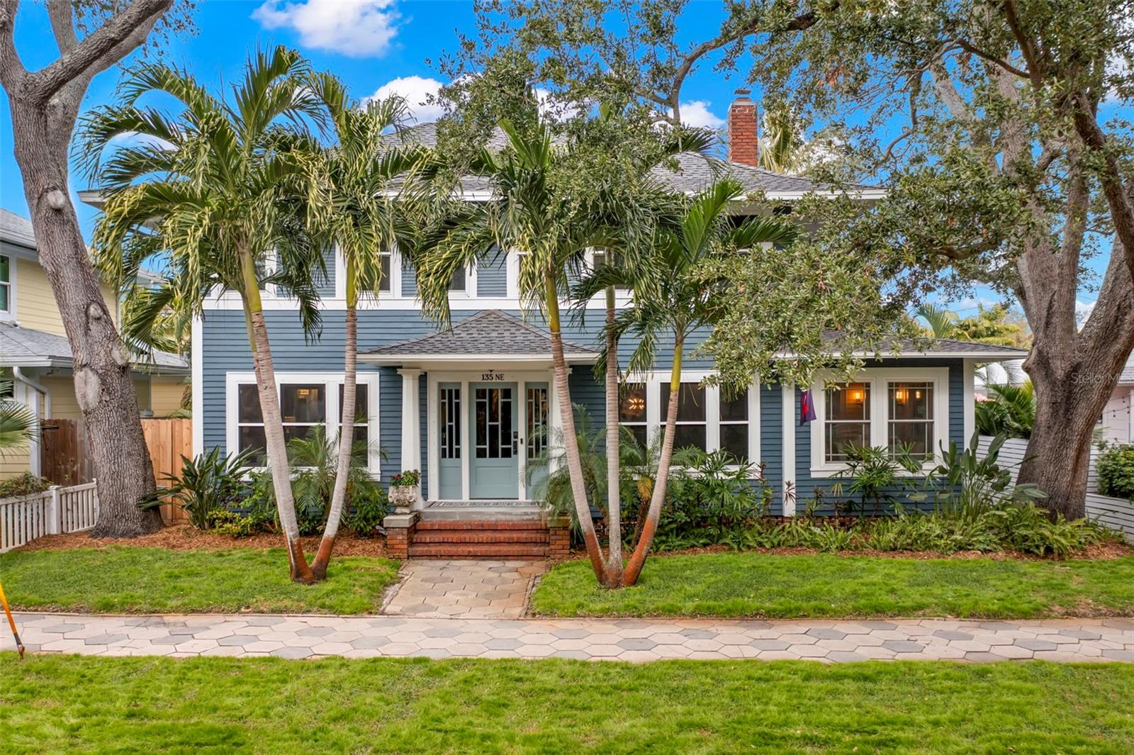 This meticulously restored 1917 Prairie-style home offers a rare opportunity to own a piece of architectural history, blending period charm with all the modern conveniences of today! Located within steps of the vibrant downtown and waterfront parks of St. Petersburg, yet high and dry in a non-flood zone (evacuation zone D), and protected by new PGT hurricane impact windows and a newer roof with hurricane clips. Situated on a generous 60'x127' deep lot, it allows for a covered portico for outdoor dining and entertaining, a spacious pool with sunshelf, spa, and an oversized two-car garage with a one-bedroom guest suite above with a full kitchen, bath and laundry. The current owners lovingly preserved the original heart pine wood floors, plaster walls, moldings, doors, built-ins and hardware throughout. The warm and inviting living room boasts the original brick fireplace upgraded with natural gas, Cuban tile hearth, built-ins and wood box beam ceilings. Take in the Florida sunshine in the enclosed sun porch with the original Cuban tile floors and lots of windows for natural light. Plenty of space to entertain your guests in the large dining room with original built-in Craftsman cabinets stained to match the period trim and moldings. The gorgeous new white kitchen features a natural gas range, shaker-style white cabinets, granite countertops, a large island with waterfall edging, stainless appliances, a wine cooler and two dishwashers. A laundry room, powder bath, and a spacious bedroom with ensuite bath round out the downstairs. Retire upstairs to two bedrooms with walk-in closets, a renovated bath with a large shower and dual sinks, plus a bonus space that can be utilized as another bedroom, home office, fitness/yoga, or tv room. The best of indoor-outdoor living awaits you in your private backyard oasis! Open up the French doors off the kitchen for seamless entertaining onto the covered portico that highlights a built-in grill, prep sink and ice/condiment cooler. Relax poolside by the assortment of palm trees, tropical plants, and pavers that surround a large PebbleTec heated pool and spa, along with a dedicated pool bath with a walk-in shower, an outdoor utility sink and cabinets. Parking for up to 5 cars in the oversized two-car garage and on the parking pad behind the alley (a rarity and bonus this close to downtown). Schedule a private showing today to see an extremely well-loved and cared-for home in pristine condition and take in the best of Florida living with an easy stroll to downtown and the waterfront!