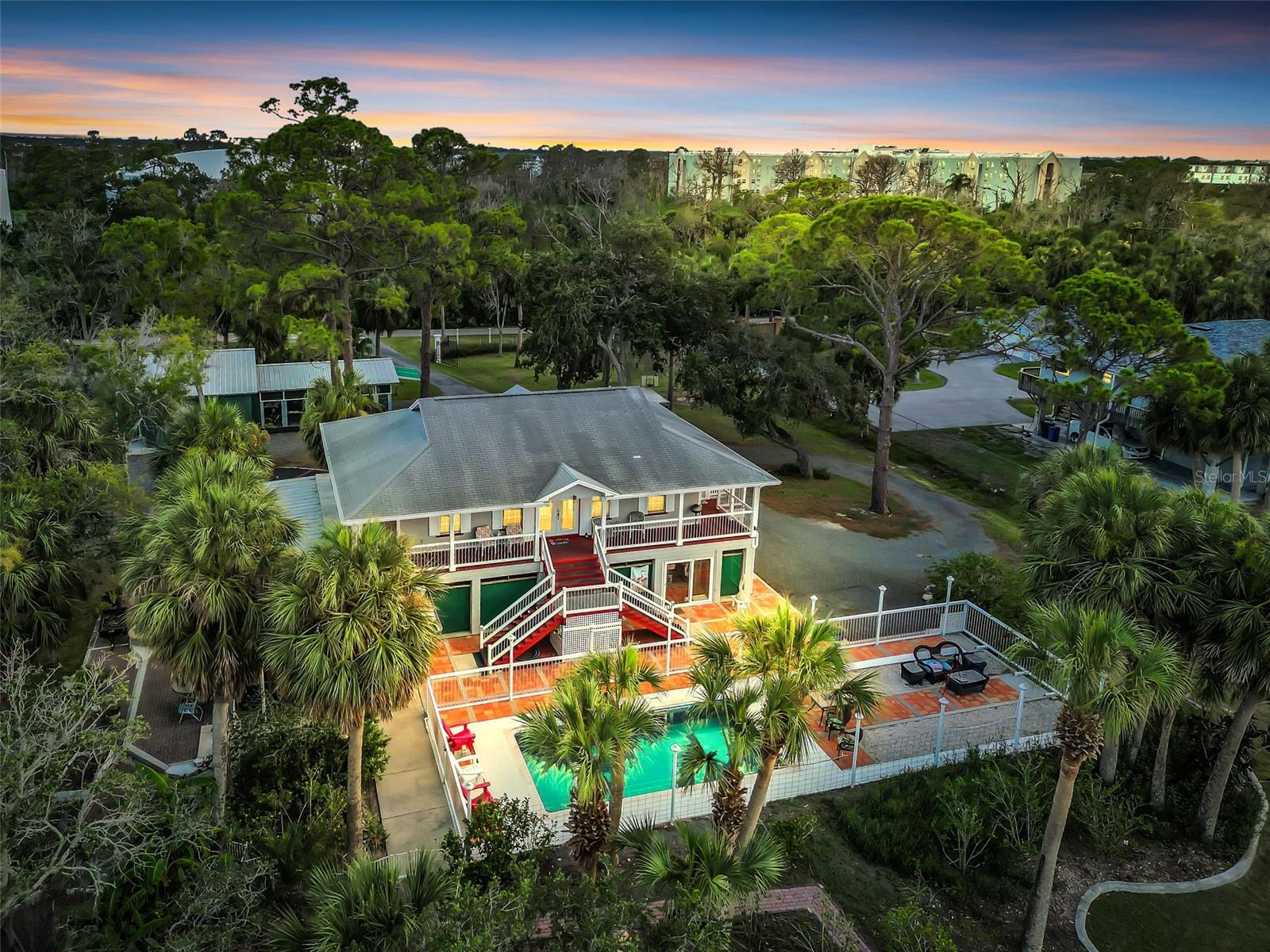 WATERFRONT PARADISE! Elevated home on 2.3 PRIVATE ACRES WITH GULF ACCESS – Just 1.5 Miles from Downtown New Port Richey!
Don’t miss this rare opportunity to own a stunning, fully renovated waterfront retreat situated on 2.3 acres with 240 FEET OF DIRECT FRONTAGE on Cross Bayou, offering easy access to the Gulf of Mexico! This expansive, private estate delivers the ultimate Florida lifestyle—golf cart friendly and ready for entertaining, relaxing, and exploring the water. This beautifully updated 4-bedroom, 3-bathroom home seamlessly blends style, comfort, and functionality. The gourmet kitchen is a showstopper, featuring slate tile floors, contemporary soft-close cabinetry, a large granite island, custom lighting, stainless steel appliances including a new LG convection oven, vented range hood, microwave, tile backsplash, and a porcelain farmhouse sink. French doors with built-in blinds open up to incredible pool and water views.
The spacious primary suite offers custom-built closets and a luxurious spa-style bathroom with a large walk-in shower with dual shower heads, a mahogany vanity, and double pedestal sinks. Two additional bedrooms share a beautifully renovated full bath. Enjoy expansive water views from the open living area or step outside to your private 12’ x 24’ saltwater pool, featuring a brand-new 2025 pool pump, liner and new volleyball set. A rec room, built-in charcoal grill, covered work benches, and included pool table make this home entertainment ready. Additional Features Include: Exterior elevator lift that makes bringing groceries in a breeze or it could be used for a wheelchair, Custom lighting, Interior laundry with washer and dryer, Large Game/entertainment room for hosting events, 1,000-gallon septic tank, Built-in closets throughout. The property is equipped with water, a dedicated drain, and a 220V outlet, making it RV-ready and perfect for convenient parking and hookup. The massive pole barn offers plenty of versatile space—perfect for storing extra vehicles, boats, recreational gear, or even setting up a workshop or greenhouse. The expansive lot still leaves ample room for future additions like a pickleball court, putting green, or anything else you envision. An air compressor is also included in the sale. This is more than just a home—it’s a lifestyle. With golf cart access and proximity to downtown New Port Richey, you'll enjoy the perfect mix of privacy and convenience. Whether you're looking for a primary residence, vacation home, or smart investment, this property truly has it all. Schedule your private tour today—homes like this are rarely available!