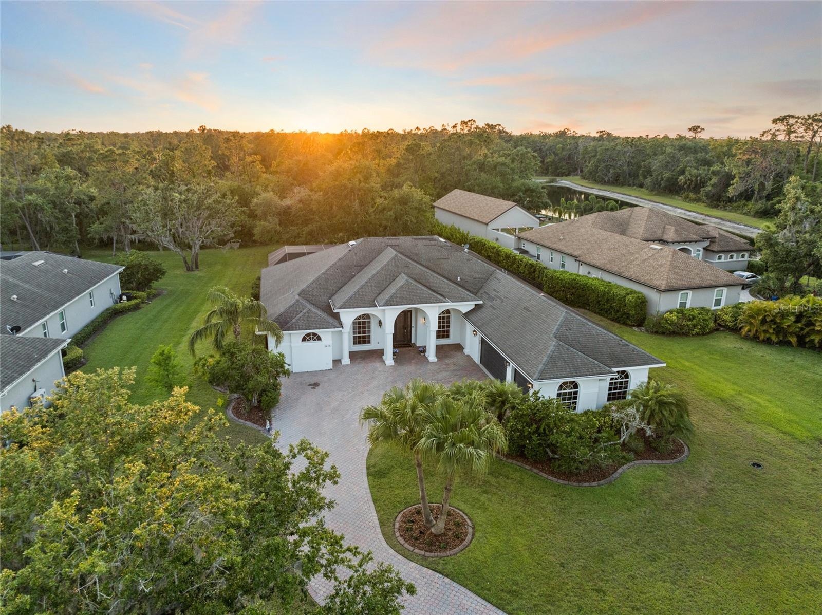 Experience the pinnacle of luxury living with this extraordinary property that has been meticulously remodeled in 2023. This stunning estate is a true masterpiece of design and craftsmanship, showcasing high-end finishes and sophistication at every corner. As you step inside, you are immediately welcomed by an aura of grandeur. The formal living room sets the perfect stage for your grand piano, radiating elegance throughout the entire home. At the heart of this residence lies the magnificent chef’s kitchen, featuring exquisite waterfall quartz countertops that gracefully shape a spacious island, accommodating up to five guests. Outfitted with top-of-the-line THOR appliances, a wine fridge, a custom oak-wrapped exhaust hood, a herringbone marble backsplash, and designer light fixtures, this kitchen transforms culinary moments into delightful gatherings for family and friends. Flowing seamlessly from the kitchen, the living room impresses with its captivating design, highlighted by a breathtaking floor-to-ceiling porcelain slab complete with a built-in fireplace and entertainment center. The exquisite woodwork and backlit tray ceilings create a perfect fusion of style and comfort that invites relaxation and entertaining alike.
When ready to unwind, retreat to the owner's suite, a true sanctuary of serenity. With its own fireplace and luxurious vinyl plank flooring, this tranquil space leads to a dream closet featuring 360 degrees of custom cabinetry, ideal for effortlessly showcasing your wardrobe. The spa-like ensuite bathroom elevates relaxation to new heights, boasting dual quartz countertops, a spacious soaking tub, and a walk-in shower adorned with stunning floor-to-ceiling tiles. For entertaining, prepare to be wowed by the outdoor living area. Open the expansive pocket sliders to create a harmonious blend of indoor and outdoor spaces. The lanai is perfect for gatherings, featuring a gas outdoor kitchen with beautiful waterfall marble counters, a grill, a sink, a fridge, and ample storage. Picture yourself enjoying family dinners around the quartz island with seating for six while basking in the inviting spring air. Afterward, dive into your newly resurfaced pool and spa for the ultimate relaxation. Set on nearly three-quarters of an acre, this property offers a peaceful retreat, surrounded by nature's beauty. Additional Features & Upgrades Include: a spacious 3-car garage, a whole-home speaker system, motorized blinds, fully updated bathrooms, 3 additional bedrooms, a generous office space, a paver driveway, and a new roof coming soon, among countless other enhancements! Nestled in the prestigious Twin Rivers community, which boasts low HOA fees and no CDD fees, this estate grants you premium access to a gated boat ramp leading to the Manatee River, a community river house, two docks, basketball and volleyball courts, a soccer field, multiple playgrounds, serene lakes, scenic nature trails, and so much more! This is your opportunity to own the home of your dreams. Don’t wait—schedule a showing today and step into your new luxurious lifestyle!