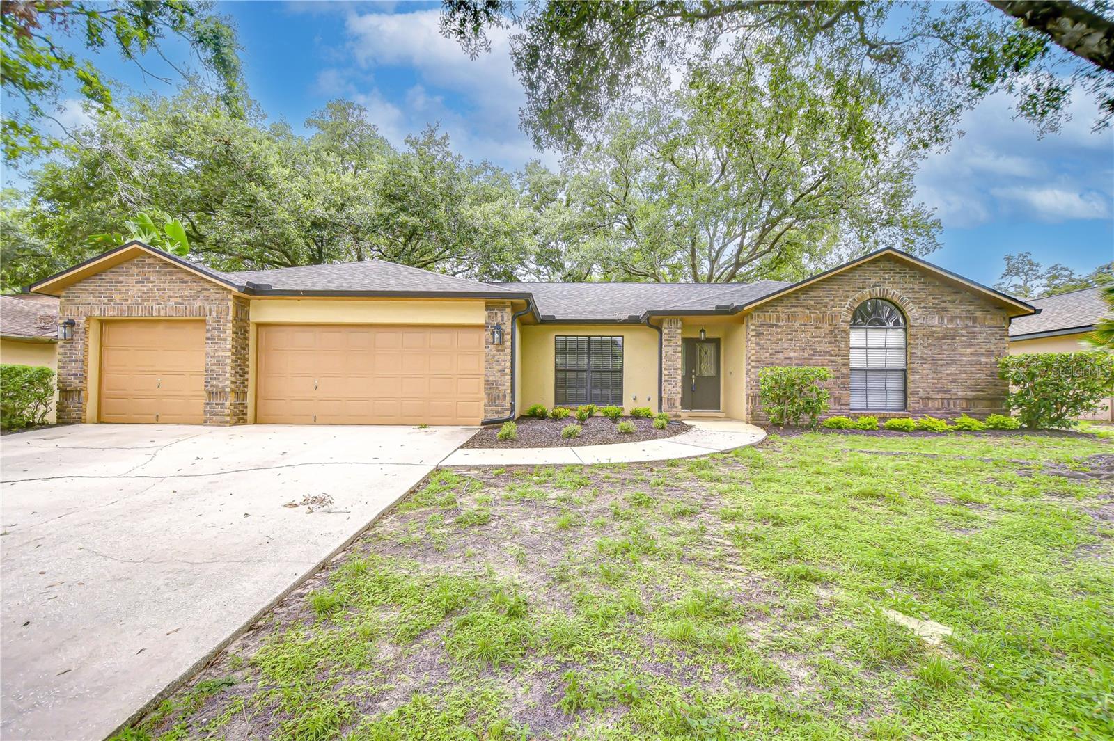 This home in the heart of Brandon offers incredible value with a LOW HOA and NO CDD fees, making it the perfect opportunity for multigenerational living or additional rental income with a rare attached 1 bed/ 1 bath in-law suite! Offering over 2,800 square feet of living space, this well-maintained property features 4 bedrooms and 2 bathrooms in the main house with a desirable split floor plan, formal living and dining areas, and a spacious family room centered around a beautiful brick wood-burning fireplace, adding warmth and charm. The remodeled kitchen, completed in 2020, is the heart of the home—featuring stainless steel appliances, sleek countertops, modern cabinetry, recessed lighting, and a stylish bar area with floating shelves, ideal for entertaining or casual mornings. Sliding glass doors off the kitchen lead directly to the expansive screened lanai, offering seamless indoor-outdoor living perfect for relaxing or hosting guests. Throughout the home, you’ll find updated engineered hardwood flooring and new carpet installed in 2020, along with upgraded ceiling fans, modern hardware, and updated switches—all enhancing the home’s functionality and style. Additional updates include a new roof and gutter system installed in 2020, an upgraded hot water heater in 2021, and a whole-home water softener system added in 2021. The interior has been freshly touched up, with tile, carpet, and grout all professionally cleaned, ensuring the home is move-in ready. The attached in-law suite offers privacy and flexibility, featuring vaulted ceilings, a large living room, full eat-in kitchen with granite countertops, private laundry, one bedroom, one bathroom with a walk-in shower, and its own screened patio—perfect for extended family, guests, or rental income. This rare floor plan also includes two separate fenced yards, providing the ultimate setup for pets, play areas, or added privacy. A spacious 3-car garage offers ample storage options. Located in an unbeatable spot for commuters, this home offers easy access to the Selmon Expressway, I-75, and I-4, making trips to downtown Tampa, MacDill AFB, and surrounding areas a breeze. You’ll also enjoy being close to the Brandon Mall, top-rated dining, shopping, and medical services. Homes with this level of flexibility, thoughtful upgrades, and prime location are hard to come by—schedule your private showing today! Copy and paste this link to tour the home virtually: my.matterport.com/show/?m=aTFXeojt5Mi&mls=1