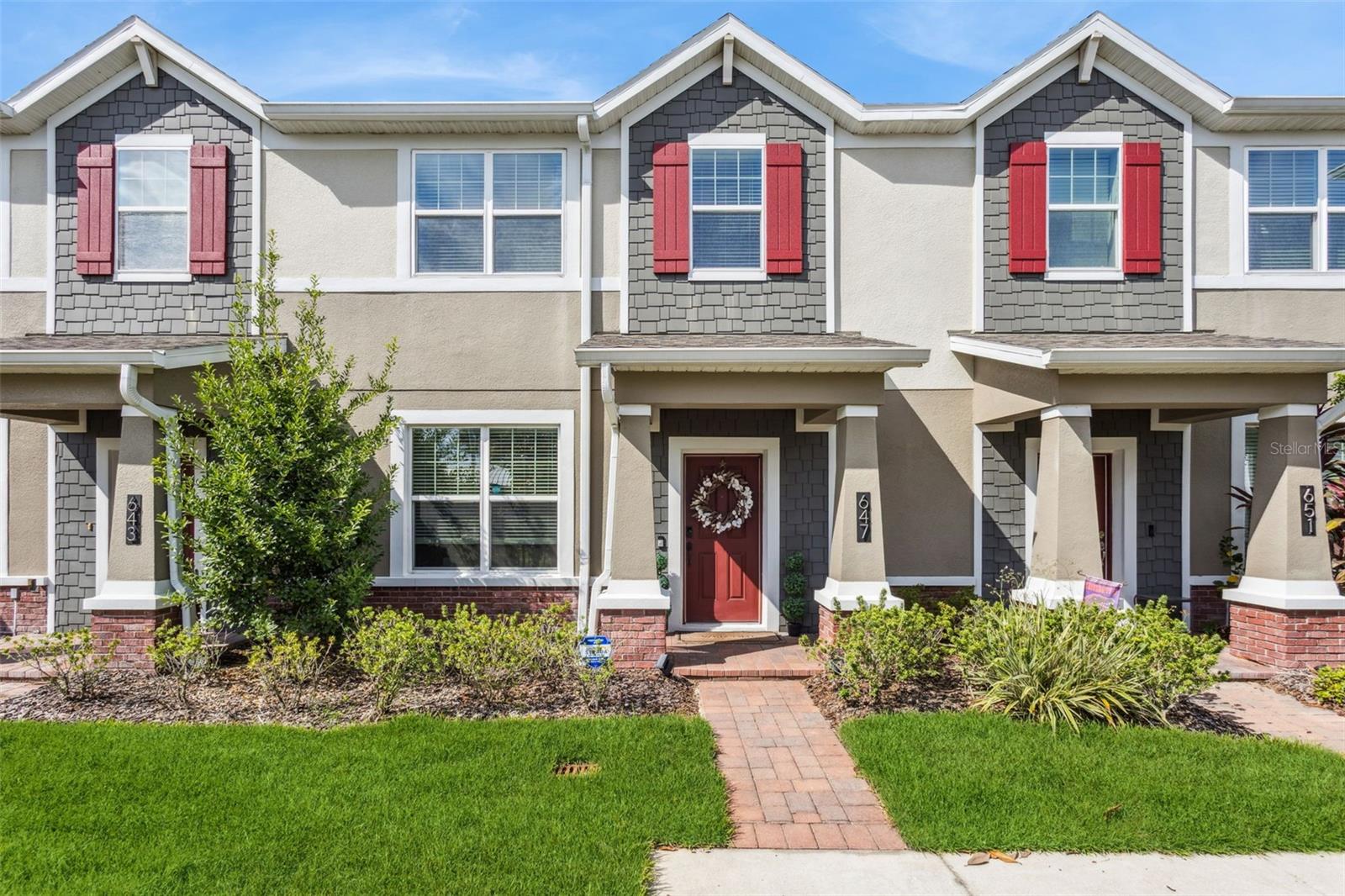 An unbelievable opportunity has become available in the quaint town of Winter Garden! Get your golf cart charged up as you call this special place home. If strolling or fitness is your hobby, this town has it all. A special place taking you back in time, while walking, running, and biking are available on the West Orange Trail that goes right through the town. This special town is sprinkled with restaurants, merchandise boutiques, historical buildings and plenty of bakeries and ice cream stores to cure that sweet tooth. A local brewery supports with town with special events while the mayor makes sure every holiday is celebrated, whether that is a parade, holiday music or fireworks! This leader can be seen strolling around the farmer’s market every Saturday. While the town in nestled around Lake Apopka, you have easy access to major expressways and Themed Parks. Now get ready to visit Heritage at Plant Street. This newer community is nestled between the bike park and library. It is full of neighborhood activities and complete with a neighborhood pool, walking path and a dog park. As you pull in, get ready for the magic of carefree living. As you turn pass the pool, welcome to 647 East Plant Street. Only a select few can have the opportunity to live in these wonderful townhomes. As you walk up your paver walkway, expect to be impressed with the lush landscaping. March through the door and explore the breathtaking great room with beautiful wood plank tile. This great space leads to the open kitchen with a large island for family gatherings. This gourmet kitchen includes natural gas stainless steel appliances, cooktop with designer hood and a build in oven and microwave: a finish even the pickiest chef would enjoy. A nice sized table can be added for extra seating as well. The downstairs also included a large, laundry room, ½ bath and ample storage underneath the stairwell. The magic continues as you exit passed the built-in drop zone to your backyard paradise. This screened and paver back yard can become your private retreat to relax. Beyond your backyard is your 2-car garage to park your car and golfcart. When you are ready to retire for the evening, head up the stairs to your 3 private suites. The primary bedroom will accommodate the largest furniture you can imagine! The private bath has double sinks, large shower, private commode, and a large walk-in closet. The additional 2 junior suites share the second full bath. Being footstep from the trail with newer construction is rare, make your private appointment today while the opportunity still exists.