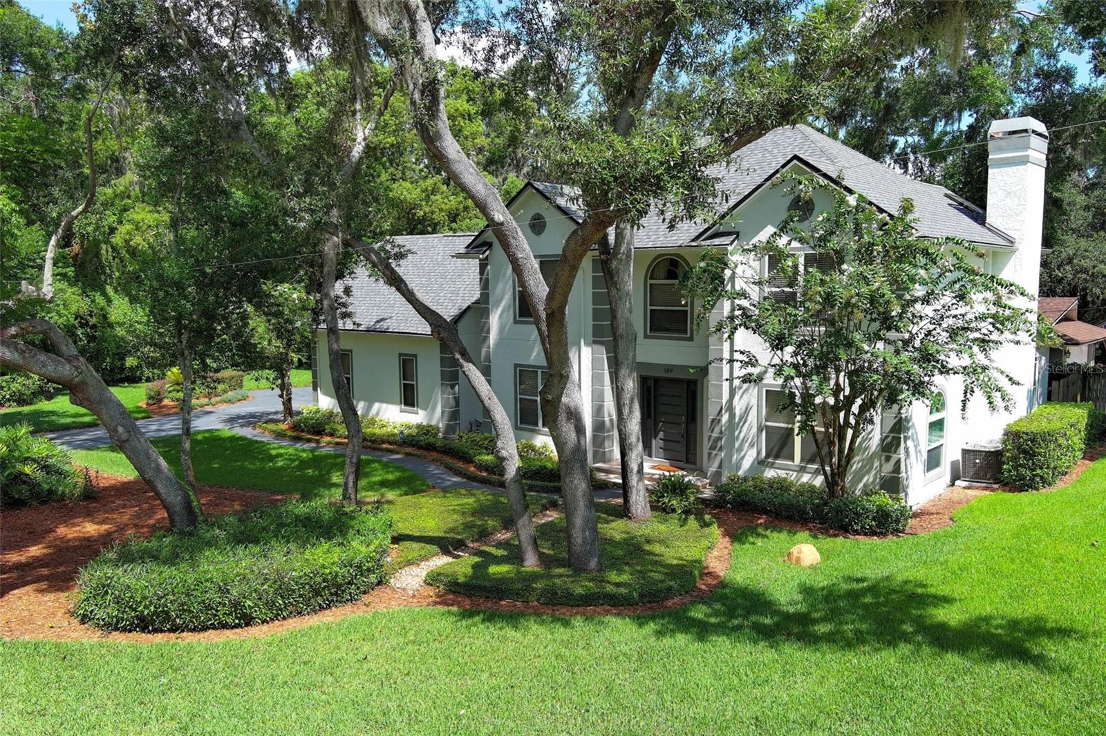 Modern upgrades meet timeless Windermere charm in this fully reimagined four-bedroom, three-and-a-half-bath home, just steps from Lake Bessie. Set on a beautifully manicured corner lot with no HOA, this thoughtfully updated property blends luxury, comfort, and functionality in one of Central Florida’s most desirable communities.
Every detail has been considered—NEW ROOF, NEW A/C, NEW PLUMBING, NEW FLOORING, NEW DRAINFIELD, NEW WATER FILTRATION SYSTEM, and fresh paint inside and out ensure peace of mind for years to come.
The heart of the home is a showpiece kitchen designed for serious cooking and stylish entertaining, with soft gray shaker cabinetry, quartz countertops, a central island with induction cooktop and chimney hood, double wall ovens, mosaic glass backsplash, and all-new stainless appliances.
Natural light pours into the open living and dining areas, grounded by marble-look porcelain tile and anchored by a cozy fireplace. Step through French doors into a backyard designed for year-round enjoyment—featuring a sparkling pool and spa, sun deck, pergola, and lush landscaping.
The primary suite feels like a spa retreat with a freestanding soaking tub, rainfall shower with frameless glass, dual-sink wood vanity, brushed gold finishes, skylight, and elegant marble-look tile. The oversized fourth bedroom, complete with fireplace and built-ins, easily functions as a media room, home office, or guest suite.
Located near top-rated schools, boutique shops, parks, and the Butler Chain of Lakes—with easy access to downtown Orlando, major highways, and Orlando International Airport—this Windermere gem offers a lifestyle as exceptional as its design.