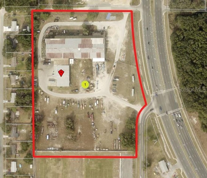 10.77 Acres Zoned C-2, currently used for Industrial/Manufacturing.  Signalized Intersection with double road front access.  Directly on US Hwy 441/27 and N. Dixie Hwy.  Incorporated into the City of Fruitland Park.  FDOT Traffic Count 29,500 Daily. Pressure Main Sewer is located on Hwy 441, same side of the road. City Water is located on all 4 sides, 6" and 8".  Industrial/Manufacturing and Office/Storage - 3 Buildings, largest is 51,068 sqft., use is Industrial/Manufacturing.  Clear span, red iron/concrete block/metal siding with multiple overhead doors. Many offices, plenty of storage, central air.  This building also includes an additional 6912 sqft mezzanine accessed by an elevator & staircase. Adjoining building is 3360 sqft. with a 1200 sqft. covered metal roof overhang w/loading dock. 1971 year.  Second building currently is being used for Office/Warehousing. 7590 sqft. built in 1981. Concrete Block/Masonry.  3rd Building - storage at 520 sqft.  The zoning allows for many uses.  Retail, banks, sales, restaurants, office, industrial limited operations engaging in fabrication, repair or storage of manufactured goods. Laboratory/research and development, dry cleaning facilities, motor vehicle towing, warehousing, distribution centers, all permitted C-2 Uses, along with several other conditional permitted uses.