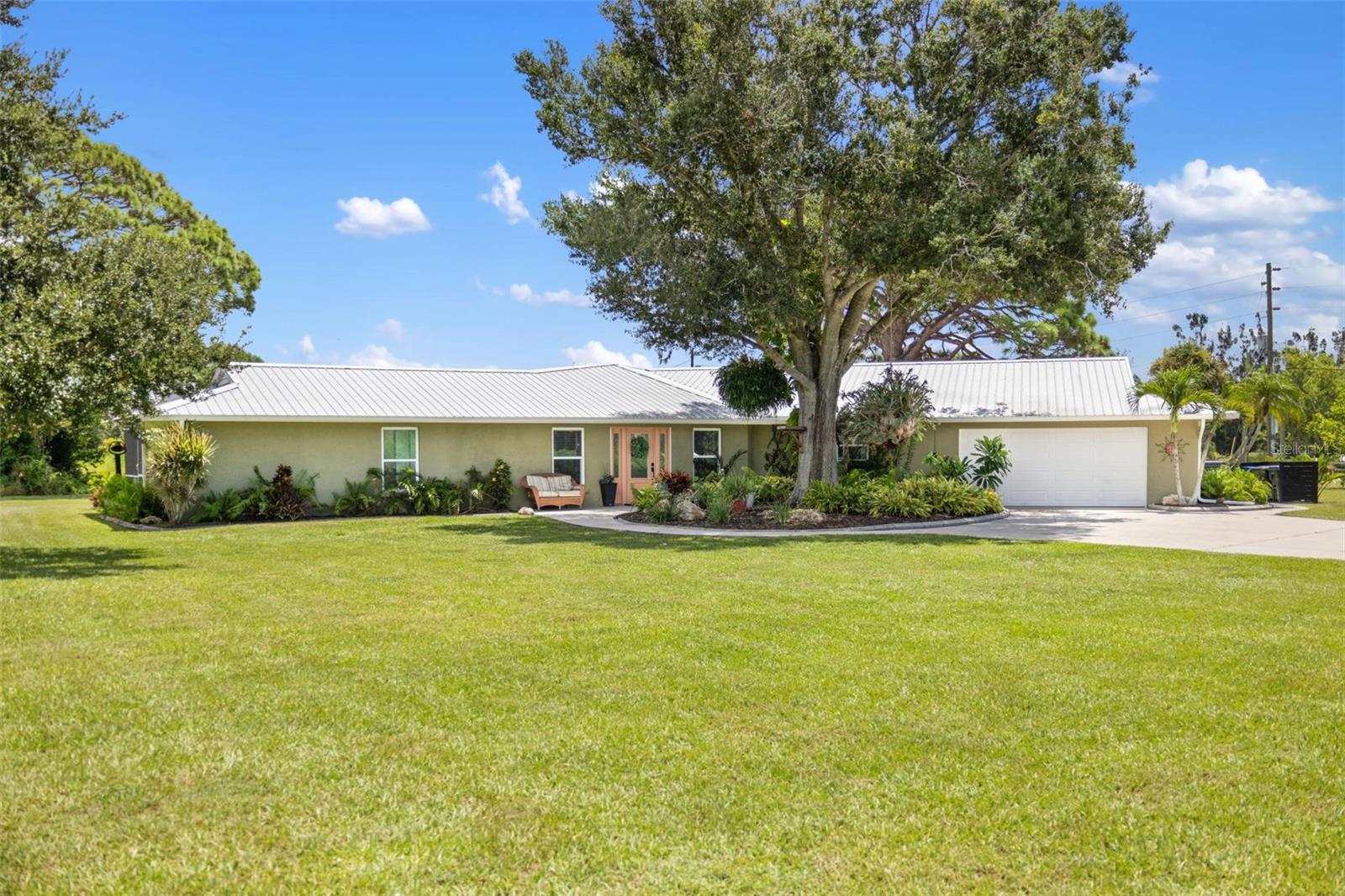 Welcome to this one-of-a-kind estate, where luxury living meets serene country charm. Set on just over 3 acres—including a fully stocked private pond and room for horses—this home was designed for those who crave peace and privacy. Perfectly positioned on a quiet private road, this immaculate 3-bedroom, 3-bathroom home is a space to enjoy for years to come. Step inside and you’ll immediately notice the spacious, open layout with over 3,000 square feet of thoughtfully designed living space. The heart of the home is the chef’s kitchen, complete with rich wood cabinetry, stainless steel appliances, quartz countertops, a wine cooler, and bar seating that flows effortlessly into the great room, making it the ideal space for everyday living. Each of the three generously sized bedrooms features its own ensuite bathroom, offering comfort and privacy for all in this split bedroom layout. The luxurious primary suite boasts LVP flooring, a walk-in closet, and a spa-worthy ensuite bath tucked behind a barn door, showcasing a soaking tub, glass-enclosed shower with striking floor-to-ceiling tile, dual quartz-topped vanity, and an LED mirror. An indoor laundry room adds everyday convenience. Step outside through double sliding glass doors to your screened-in lanai, where pavers surround a resurfaced PebbleTec in-ground pool—your private outdoor oasis. There’s also a detached block garage with electric—ideal for a workshop, extra storage, garage or even future guest space. Recent upgrades offer peace of mind, including a new HVAC in 2024, re-piped plumbing, two new water heaters, a metal roof, dual septic systems and County water is already in place! This equestrian-zoned property has its own fully stocked pond, all you need is your fishing pole. Conveniently located near local school bus stops and the peace of mind that comes with being zoned for top-rated schools including Laurel Nokomis Elementary & Middle, and Venice Senior High. Spend your weekends exploring the scenic Legacy Trail or hiking through Oscar Scherer State Park. Craving sand and saltwater? The Gulf is calling—just 2 miles away, you’ll find a beautiful local beach with a public boat ramp offering quick access to the Intracoastal Waterway for kayaking, paddleboarding, or a day out on the boat. This location combines the best of both worlds: tranquil acreage and seamless access to the surrounding Gulf Coast lifestyle. Schedule your showing today!