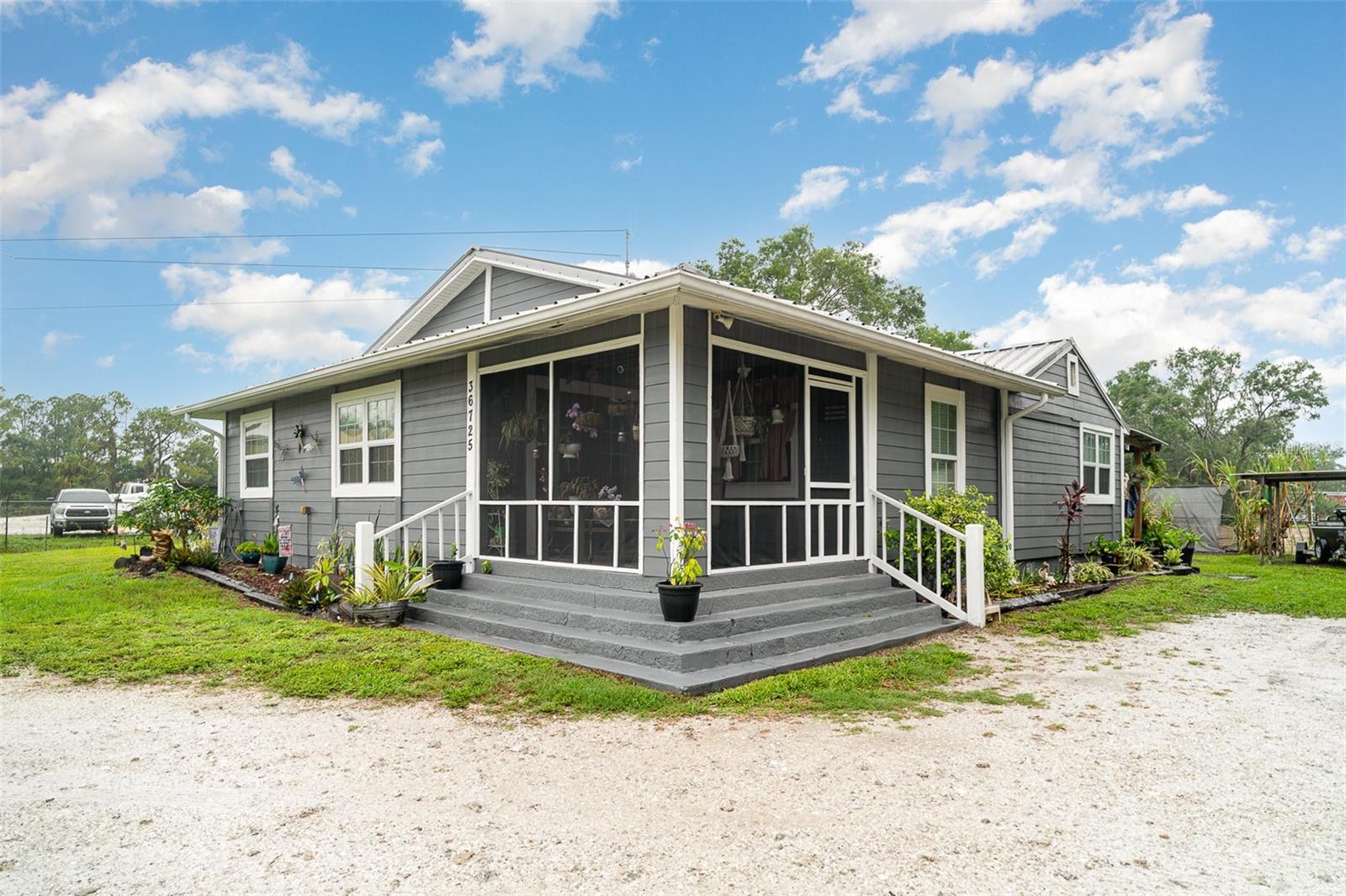 Welcome to your charming country retreat! This spacious 3-bedroom, 2-bath home offers a peaceful setting with thoughtful updates throughout. The open split floor plan features vaulted ceilings, custom wood kitchen cabinets (installed in 2020), and a cozy eat-in kitchen with plenty of storage. Enjoy year-round comfort with multiple ceiling fans throughout and a dedicated laundry room for added convenience. One bathroom was fully remodeled in 2024 with new flooring and a sleek rain standing shower. Air ducts were professionally cleaned in 2025, and the home’s exterior received a fresh coat of paint the same year. Outdoor living shines here with a cozy front porch, a fenced yard, a deck built around the pool, and multiple outbuildings. There’s no shortage of space with several storage sheds, a chicken coop, and even a barn equipped with an outdoor kitchen, water, and electricity—perfect for entertaining or projects. This home blends country charm with practical updates for comfortable living inside and out!