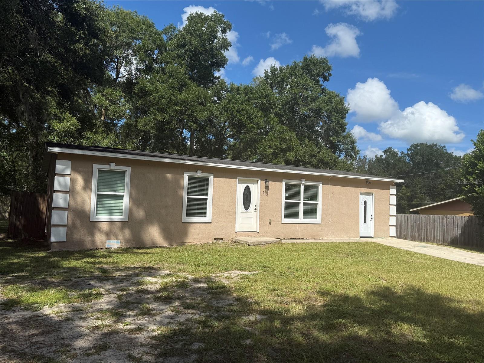 Discover the perfect balance of peaceful country living and everyday convenience in this spacious 3-bedroom, 2-bath home set on nearly a quarter acre. With no carpet throughout, the home is designed for easy maintenance and comfort. The layout offers both a cozy den and a separate family room, giving you flexible spaces to relax or entertain. Step through charming French doors (no sliders here!) into your fully fenced yard, ideal for pets, play, or simply enjoying the outdoors. The oversized yard also provides plenty of room to bring your big toys—perfect for RVs, boats, or trailers. This home also features the practicality of a well and septic system, ensuring lower utility costs, and its location gives you the best of both worlds—quiet country-style living with easy access to shopping, dining, and major roads.