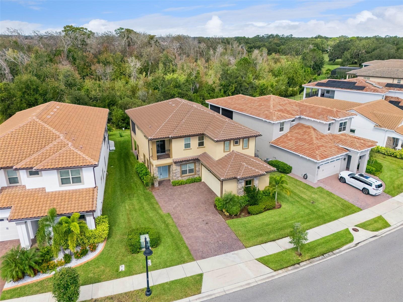 Welcome to luxurious living in the guard-gated Eagle Creek community of Lake Nona!
This home was constructed in 2022, boasts 5 spacious bedrooms and 4 modern bathrooms, offering a generous 3,339 square feet of meticulously designed living space. 
As you enter, you are greeted by high ceilings and an abundance of natural light that flows throughout the thoughtfully planned open-concept layout. This design harmoniously connects the welcoming foyer with the expansive living room, elegant dining area, and gourmet kitchen, making it perfect for both daily family life and entertaining guests. The chef’s kitchen is a dream, featuring state-of-the-art premium stainless steel appliances, stunning granite countertops, and a large central island with seating, ideal for culinary adventures and social gatherings.
On the first floor, you’ll find a versatile room currently staged as a home office, which includes a spacious closet and private access to an attached full bathroom. This thoughtful design makes it an excellent space for visiting grandparents or guests, allowing for privacy and convenience. 
Venture upstairs to discover a versatile loft area, perfect for a media room, play zone, or an additional living space. The primary suite is a true retreat, showcasing a spa-style ensuite bathroom complete with dual vanities, a luxurious walk-in shower equipped with modern fixtures, and an impressive walk-in closet that provides ample storage. Sliding glass doors lead to a large screened balcony, offering tranquil wooded conservation views that enhance your privacy. This balcony is conveniently shared with the third bedroom, which would also make an ideal home office with its quiet ambiance.
The fourth sizeable bedroom features ample closet space, its own private balcony, and shares access to a split full bathroom. The fifth bedroom, located off the loft area, includes a private ensuite bathroom, adding an extra level of comfort for guests.
Outdoor living is at its finest with a covered patio, perfect for al fresco dining that overlooks the expansive backyard. This serene setting invites you to enjoy morning coffee, unwind in the evenings, or host gatherings with friends and family.
Residents of Eagle Creek enjoy a wealth of resort-style amenities, including 24-hour gated security, a luxurious clubhouse, resort-style pools with sun loungers, a family-friendly splash pad, tennis and pickleball courts, a multi-purpose field for recreational activities, scenic walking and biking trails, a fully equipped fitness center, and versatile meeting rooms. Additionally, the community boasts a championship golf course complete with an on-site restaurant, perfect for enjoying meals after a round of golf.
All of this is conveniently located just minutes away from Lake Nona’s renowned Medical City, the Orlando International Airport, top-ranked educational institutions, and a vibrant array of shopping and dining options.