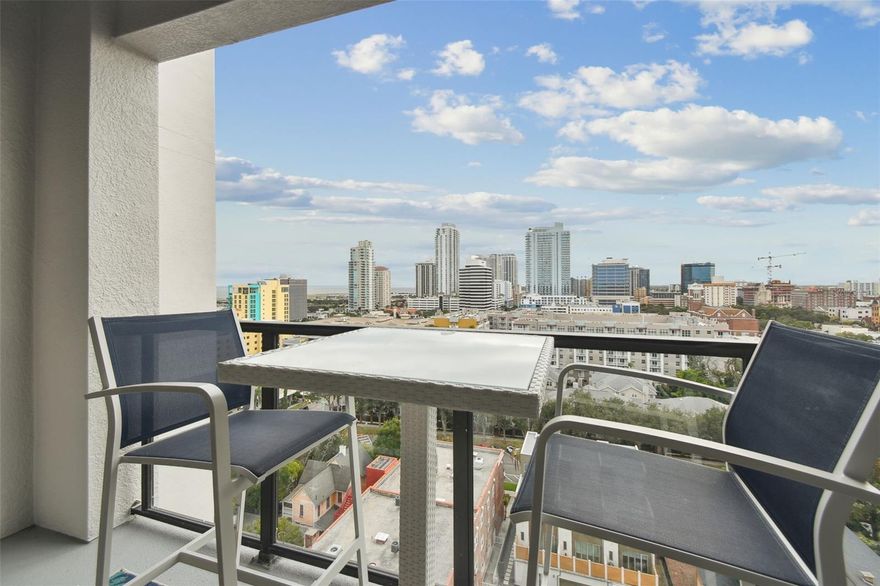 The very location-centric boutique Walker-Whitney Condos has only 56 Units with owners who know each other, make friends, and love to entertain! This exclusive unit is on the 14th floor with entrancing and extensive views of the downtown St. Petersburg area, including the basin waterfront views from the balcony opening from the combination open-concept kitchen and living room. As the 14th floor has no units above and extra insulation between the units, no neighbors above or beside can be heard. The newly renovated 2,000 sq. ft. rooftop terrace, with the assessment paid in full, is one floor above and has a sweeping city skyline and more waterfront views North and South with areas for eating and sitting, grilling, and a workout space. There is a dedicated elevator for just pets and another for those without. This location is within a few blocks of the Vinoy Hotel, Beach Drive, and the famous St. Pete Pier and across from the Palladium Theatre on 5th Avenue North. Walking or biking distance to over a hundred restaurants and world-class museums and theatres,  St. Petersburg has ranked for years as the number one mid-size city in Arts and Culture; festival heavy, and with the dedicated parking space in the covered garage, you now never have to worry about finding a spot to park downtown! This remodeled and unique unit has custom Epoxy white floors and a white kitchen, making it open to sunlight and bright with a built-in pantry and tasteful blinds and drapes. The Primary bedroom has a walk-in closet and double sinks and is well-sized with tall windows on the entire south side of the unit. The second bedroom is off the living room, showing as a den or extension of the living room, yet complete with a full bathroom and another walk-in closet. The back room is an office with the washer/dryer off the office and half bathroom. The unit is in beautiful condition and well-maintained, and the AC has just been serviced. Walker-Whitney has easy access to the Interstate, shopping, and renowned hospitals nearby. Come and enjoy the downtown lifestyle.