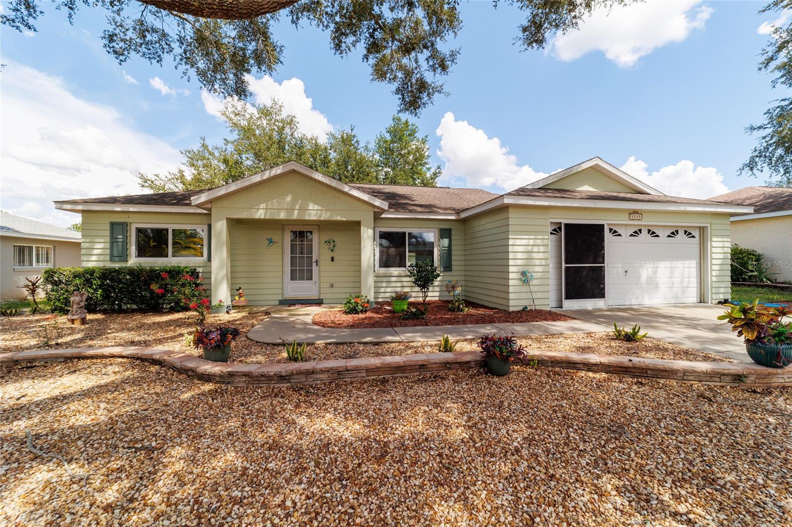 Beautifully Updated Seville Model in Crescent Ridge 2 – Pet Friendly with Modern Upgrades!
Welcome to 9729 SW 99th Ave, a beautifully maintained Seville model located in the desirable Crescent Ridge 2 neighborhood of On Top of the World, Ocala’s premier 55+ gated community. This move-in ready home features 2 bedrooms, 2 bathrooms, and a 2-car garage, offering comfortable and low-maintenance living in a vibrant setting.
Inside, you'll find a bright kitchen with stainless steel appliances, an eat-in dining area, and neutral paint throughout. There’s no carpet anywhere, making it easy to maintain and perfect for Florida living. The open dining and living area is ideal for entertaining and includes updated recessed lighting in the kitchen, dining, and living rooms (2024), two new ceiling fans with remotes (2023), and a new garbage disposal (2023). Windows were replaced in October 2024, providing improved energy efficiency and a fresh, updated look.
The home offers a one-step entry at the front door for convenience. The garage features an epoxy-coated floor (2023) and a screen (2023), creating a clean and usable space for parking or hobbies. A covered and screened-in lanai provides a relaxing outdoor space shaded by mature trees, while the east-facing backyard helps keep things cooler during the summer. The fenced-in paver patio is perfect for relaxing or letting your pet roam safely. The lanai roof was replaced in 2023, and the back gutters have leaf guard protection and drain ten feet away from the home for proper water management.
Additional improvements include a 2018 HVAC system and a 2019 roof. This home is conveniently located near the Arbors, Veterans Park, and the Recreation Center, with golf cart access to two major shopping centers. Residents of On Top of the World enjoy world-class amenities including golf, fitness centers, pools, pickleball, restaurants, and an active calendar of social events.
Don’t miss your chance to own this updated and lovingly cared-for home—schedule your private showing today!