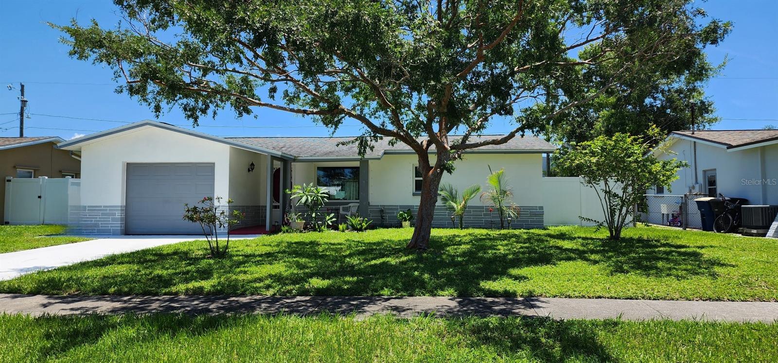 Under contract-accepting backup offers. This lovely 2 bedroom, 1 bath home has been updated and is ready for new owners to just move in and start enjoying everything it has to offer: remodeled kitchen in 2024 features white raised panel cabinets, rich black countertops, oversized sink, lighted vent hood and newer appliances. The neutral gray and white backsplash tiles tie everything together for an updated and modern look. The updated bath includes: vanity, sink, faucet, toilet, tile tub/shower surround and flooring. The white and light gray colors makes it feel bright and fresh. With white and gray porcelain tile and soft gray paint throughout, the home offers a cohesive and neutral color palette making it easy to decorate with your favorite colors. Besides the living room, there’s an additional light and bright bonus room. This is a flexible space, perfect for a home office or playroom. Make it functional for your lifestyle. A door from the bonus room leads to a screened porch with insulated composite roof. A relaxing space to enjoy your morning coffee or evening cocktail – even in the rain. There’s an additional oversized patio. Use your imagination and this could be a great outdoor living space! Oversized backyard is fenced and offers some privacy as well as protection for small children or pets. All windows were replaced in 2016 with Energy Star rated windows. In addition, there are custom hurricane fabric panels for each window and a hurricane garage door was added in 2018. Main roof replaced 2014, flat roof re-done 2013, ac 2015. Home is in a non-evacuation zone and no flood insurance is currently required. Seller states no hurricane or storm damage during her 28 years of ownership. If you’re looking for a move-in ready, well maintained home, then this is for you!