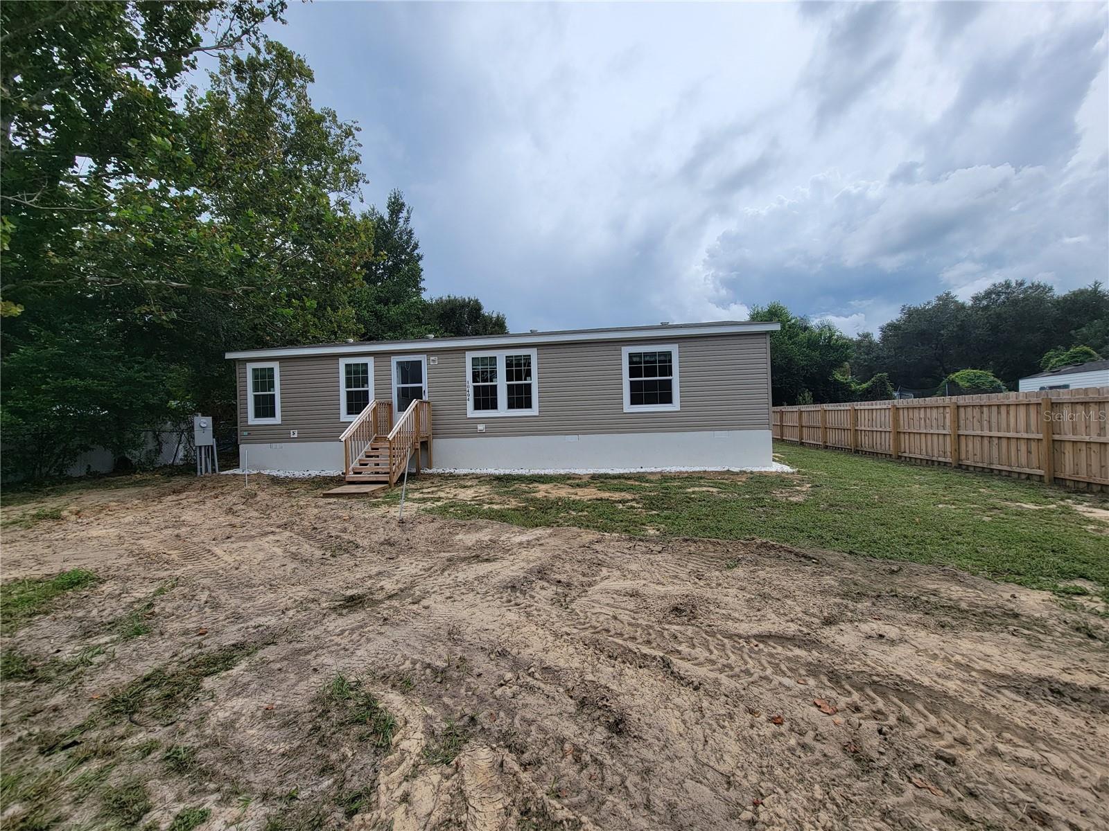 Be the very first to call this brand-new 3 bedroom, 2 bathroom double-wide mobile home your own! Tucked away in a peaceful country setting, this never-before-lived-in home combines modern style with comfort and convenience. The open-concept design features durable vinyl flooring throughout, creating a seamless flow from room to room.The kitchen is a true highlight, offering a island with generous workspace and seating, perfect for meal prep, casual dining, or gathering with family and friends. A stove, refrigerator, and built-in microwave are already in place, giving you a complete, move-in ready kitchen.The split floor plan provides a spacious primary suite on one side of the home and two additional bedrooms on the other, ideal for guests, family, or even a home office. You’ll also appreciate the indoor washer and dryer hookups, keeping laundry convenient and accessible.With its fresh finishes, modern layout, and serene country location, this home is the perfect combination of practicality and charm. This rental requires first last and security. $60 application fee for 1st adult and $40 for each additional adult. Application Fee is non-refundable.