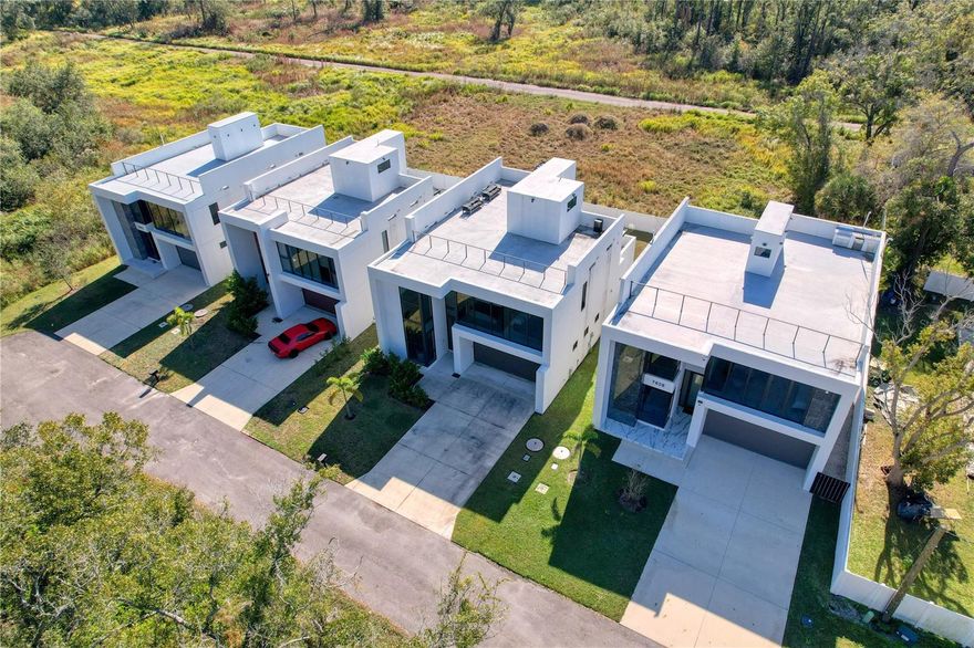 One or more photo(s) has been virtually staged. One or more photo(s) has been virtually staged.

A stunning fusion of modern design and hurricane-resilient engineering, this custom-built concrete home offers exceptional durability, luxury, and peace of mind. Constructed entirely of solid reinforced concrete from foundation to rooftop, the home features Type I fire-rated materials, termite-resistant construction, and hurricane-impact windows and doors—significantly reducing storm risk and insurance costs.

The interior showcases soaring 22-foot ceilings, floor-to-ceiling windows, and a dramatic floating staircase. Marble texture flooring, recessed lighting, and clean contemporary lines enhance the home’s refined aesthetic. The residence offers four spacious bedrooms, each with a private en-suite bathroom, plus a dedicated office ideal for remote work.

The Loomen European kitchen is equipped with premium appliances and sleek finishes, while the primary suite features a spa-inspired bathroom with a walk-in shower and soaking tub enclosed within the shower. Additional features include dual-zone climate control, EV charger, impact-rated insulated garage door, and a fully concrete-fenced backyard.

Outdoor living includes a private pool and an expansive 2,000 sq. ft. rooftop terrace with outdoor kitchen and 360-degree views. A gated entry provides added privacy and convenience. Ideally located minutes from toll access, Tampa International Airport, International Plaza, Raymond James Stadium, Downtown Tampa, and top-rated schools. No HOA or CDD fees.