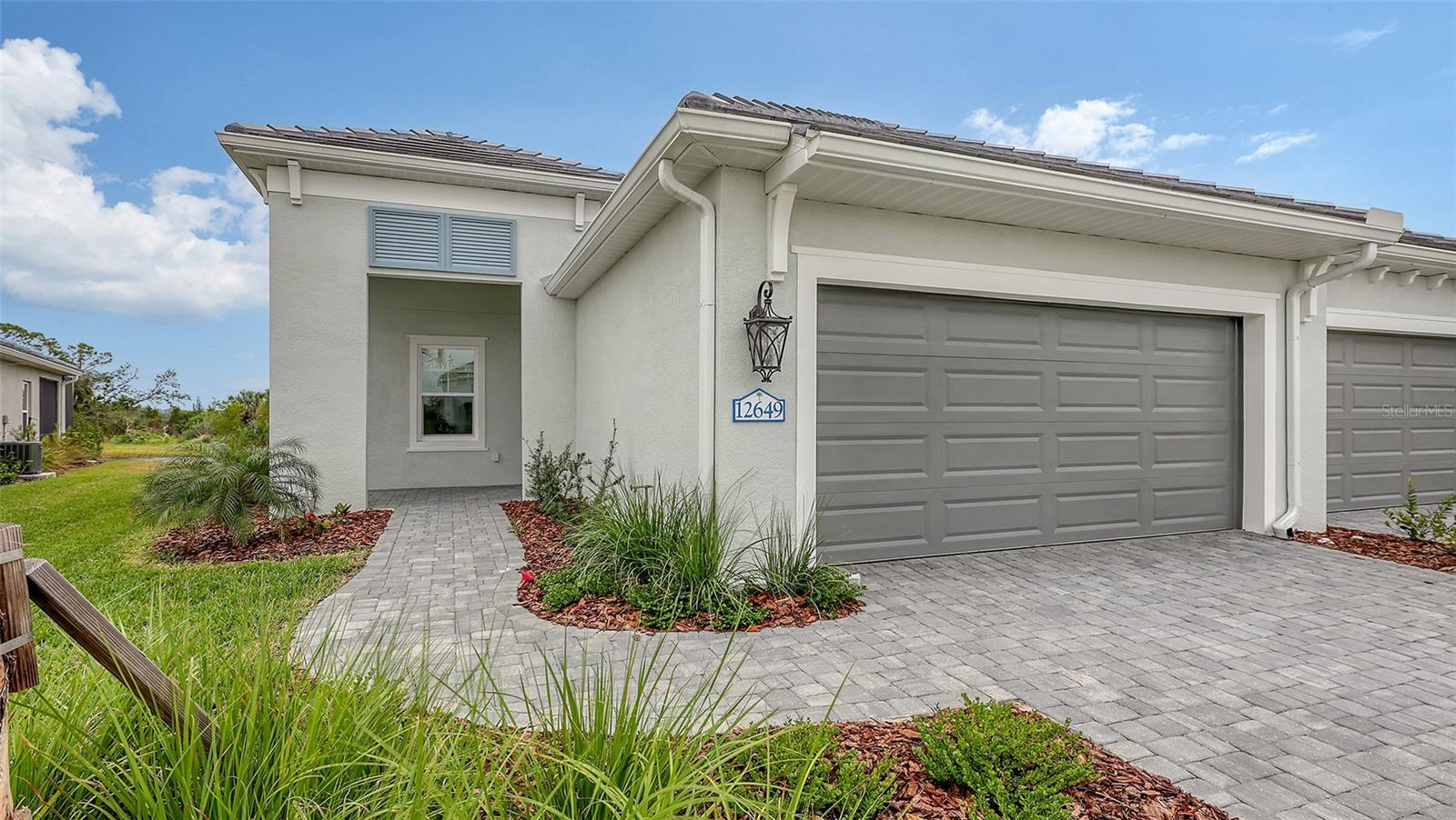 Grand Palm is a resort style, amenity rich, natural gas community located minutes to charming Downtown Venice, beautiful beaches, Wellen Park downtown and Hwy 75. This open and airy Sandcastle floor plan has wood look tile flooring throughout the home, creating a luxurious feeling. With 8' Interior doors, 9' 4" ceiling, this home feels airy and open. Upgraded kitchen featuring white cabinets and quartz counter tops, along with a large island, this kitchen is perfect for hosting. The master has a large walk-in closet as well as split vanities. The pocket sliding glass door completely opens the great room onto a large, covered, screened lanai. Impact windows and smart home features give you peace of mind. Lawn maintenance and community amenities are included in the low HOA.