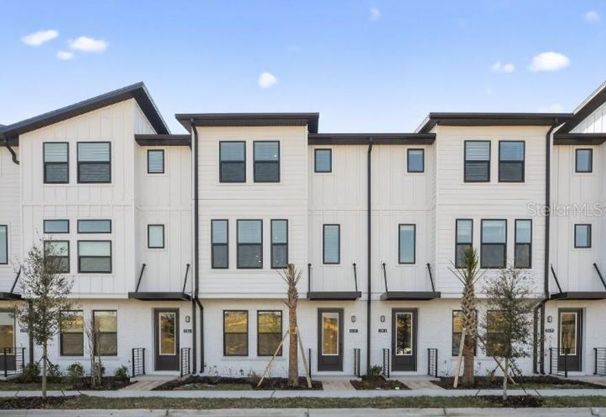 Experience modern townhome living in this beautifully designed three-story residence located in Parkview at Hamlin in Winter Garden. This thoughtfully planned home features three private suites, including a convenient first-floor suite and a spacious third-floor primary suite, offering flexibility and privacy for today’s lifestyle. The second floor serves as the heart of the home, showcasing an open-concept living room and kitchen ideal for entertaining. The open gourmet kitchen is appointed with 42" cabinets, quartz countertops, and stainless steel GE appliances, while vinyl plank flooring enhances the main living areas with durability and style. A covered lanai provides the perfect space to relax and enjoy Florida living. Designed with interiors from the AW Collection Serene, this townhome blends warm, timeless finishes and functional elegance—all set within one of Winter Garden’s most desirable communities near shopping, dining, and everyday conveniences.