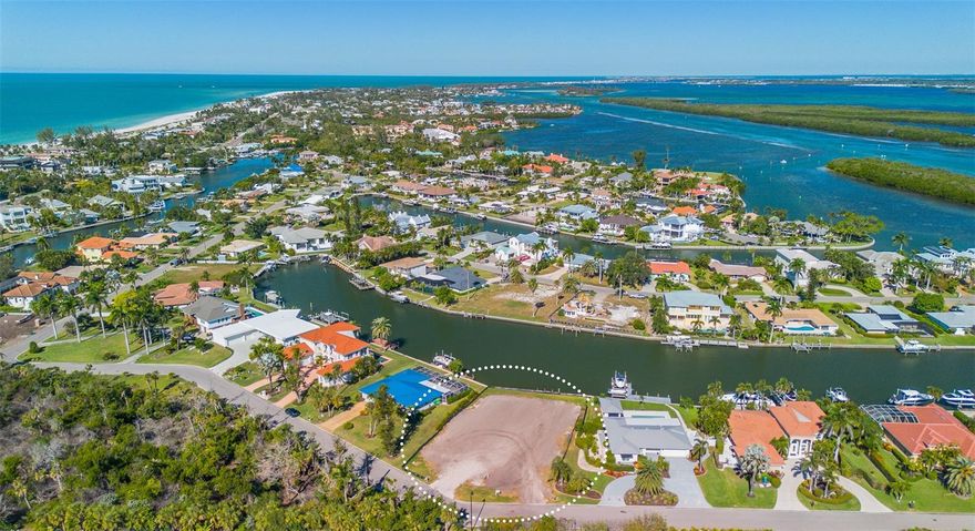PREMIER LOCATION in Emerald Harbor -- Located on the apex of the widest canal on Longboat Key, 721 Binnacle Point Drive is ready for a new owner with a new vision! The property has 96' of canal frontage with BRAND NEW Sea Wall (2024), 120' of street frontage, with just over 18,800 Square Feet upon which to build your dream home. Build new and enjoy long views east and west down the canal and the beautiful northern light exposure. Emerald Harbor is one of Longboat Key's best neighborhoods - don't miss this opportunity to create your vision! There is a working, permitted sprinkler well on property. Private, deeded beach access for Emerald Harbor residents is just over 1100 feet away.