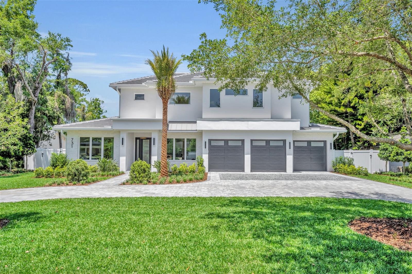 Introducing a stunning brand-new custom home by Butler Ridge Development, located in the highly desirable Park Grove neighborhood—strolling distance to Winter Park’s famed Park Avenue. This home offers timeless elegance, modern luxury, and walkable access to top-tier dining, shopping, and culture. From the inviting circular drive and professionally designed landscaping by Joe Knight, including a signature front palm that sets the tone for this elegant Florida property, every exterior detail makes a statement. Step through the inviting entry into an airy and sun-drenched interior featuring soaring ceilings, wide-plank white oak floors, oversized picture windows, and beautiful crown molding throughout. Inside, a sophisticated office with custom built-ins welcomes you, alongside a thoughtfully designed guest suite with a luxurious bathroom with roll-in shower, soft white finishes, and a custom walk-in closet—ideal for extended family or visitors.  The heart of the home is a soaring great room with 14'8" ceilings, a sleek fireplace, and a full wall of sliding glass doors overlooking the resort-style backyard. Entertain with ease in the open-concept living, dining, and chef’s kitchen—complete with a dramatic waterfall island, premium Thermador appliances (including four freezer drawers and diamond ice), dual-fuel range ovens with 6-burner gas cooktop, a 3rd oven + convection microwave, and expansive custom pantry. Adjacent mudroom and decorative laundry room. The first-floor primary suite is a tranquil retreat, featuring pool access, spa bath with soaking tub, separate shower with multiple sprayers, dual vanities, and a spacious custom walk-in closet. Upstairs, a loft-style bonus room complements the smart split-plan layout with 3 additional bedroom suites, walk-ins, and ample storage. Enjoy the best of Florida living in the beautifully landscaped backyard. Designed for both relaxation and entertaining, the outdoor living space includes a saltwater pool with elegant fountain feature, marble pavers, summer kitchen with built-in grill, sink, and beverage fridge, an outdoor bathroom, and ample grassy area for play or pets. 3-Car garage. Located within the highly desirable Dommerich Elementary, Maitland Middle, and Winter Park High School zones, and just minutes from downtown Winter Park, this home offers walkability, elegance, and convenience—wrapped into one exceptional property.