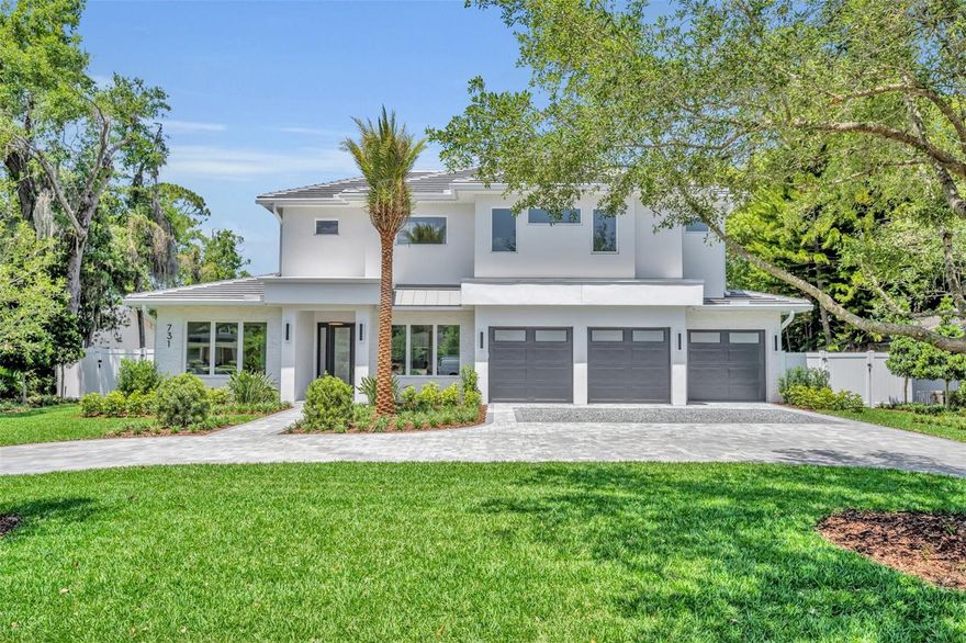 Introducing a stunning brand-new custom home by Butler Ridge Development, located in the highly desirable Park Grove neighborhood—strolling distance to Winter Park’s famed Park Avenue. This home offers timeless elegance, modern luxury, and walkable access to top-tier dining, shopping, and culture. From the inviting circular drive and professionally designed landscaping by Joe Knight, including a signature front palm that sets the tone for this elegant Florida property, every exterior detail makes a statement. Step through the inviting entry into an airy and sun-drenched interior featuring soaring ceilings, wide-plank white oak floors, oversized picture windows, and beautiful crown molding throughout. Inside, a sophisticated office with custom built-ins welcomes you, alongside a thoughtfully designed guest suite with a luxurious bathroom with roll-in shower, soft white finishes, and a custom walk-in closet—ideal for extended family or visitors.   The heart of the home is a soaring great room with 14'8" ceilings, a sleek fireplace, and a full wall of sliding glass doors overlooking the resort-style backyard. Entertain with ease in the open-concept living, dining, and chef’s kitchen—complete with a dramatic waterfall island, premium Thermador appliances (including four freezer drawers and diamond ice), dual-fuel range ovens with 6-burner gas cooktop, a 3rd oven + convection microwave, and expansive custom pantry. Adjacent mudroom and decorative laundry room. The first-floor primary suite is a tranquil retreat, featuring pool access, spa bath with soaking tub, separate shower with multiple sprayers, dual vanities, and a spacious custom walk-in closet. Upstairs, a loft-style bonus room complements the smart split-plan layout with 3 additional bedroom suites, walk-ins, and ample storage. Enjoy the best of Florida living in the beautifully landscaped backyard. Designed for both relaxation and entertaining, the outdoor living space includes a saltwater pool with elegant fountain feature, marble pavers, summer kitchen with built-in grill, sink, and beverage fridge, an outdoor bathroom, and ample grassy area for play or pets. 3-Car garage. Located within the highly desirable Dommerich Elementary, Maitland Middle, and Winter Park High School zones, and just minutes from downtown Winter Park, this home offers walkability, elegance, and convenience—wrapped into one exceptional property.