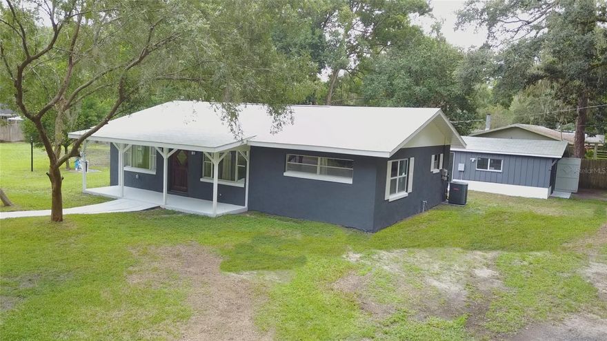 Freedom near the lake. Only 3 blocks from lake Weir, this up to date home is ready to add smiles to the future. Corner lot, consisting of half an acre on a calm road off of CR 25 and 464. Plenty of room for vehicles, jetskis, boats, campers and RVs. Bring the pets, fenced with 4 different gate entries, camper 30amp and 220V / Generator Backup hook up. Block & stucco w/ 2x6 roof construction. Roof is 1 year old. Kitchen equipped with reverse osmosis water faucet and granite countertops. Seamless Vinyl throughout. Home has a rear patio area that leads to the 1.5 car garage. Located near The Villages, Stonecrest , Del Webb and more without the FEES and restrictions. Not a spec-home. East room is also insulated for sound dampening.