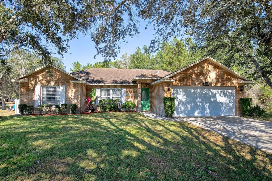 Gorgeous, updated, move in ready 3 bedroom, 2 bath, 2 car garage home is waiting for your family!  This open concept home has volume ceilings, decorator ledges, NO CARPET, NO HOA, new luxury vinyl and tile flooring, new sliding glass door with blinds inside the double panes,  stainless steel appliances, granite counters, a designer backsplash, and interior laundry room that comes with the washer and dryer. The large primary bedroom has a brand new en suite bathroom with a luxury jetted tub to relax in after a long day. So many attributes and lots of storage in this home! Enjoy the huge front yard and huge back fenced yard.  No rear or side neighbors for maximum privacy.  Walk and bike to the trails. Minutes away from Publix, Lowes, a wonderful bakery, and cool eateries.