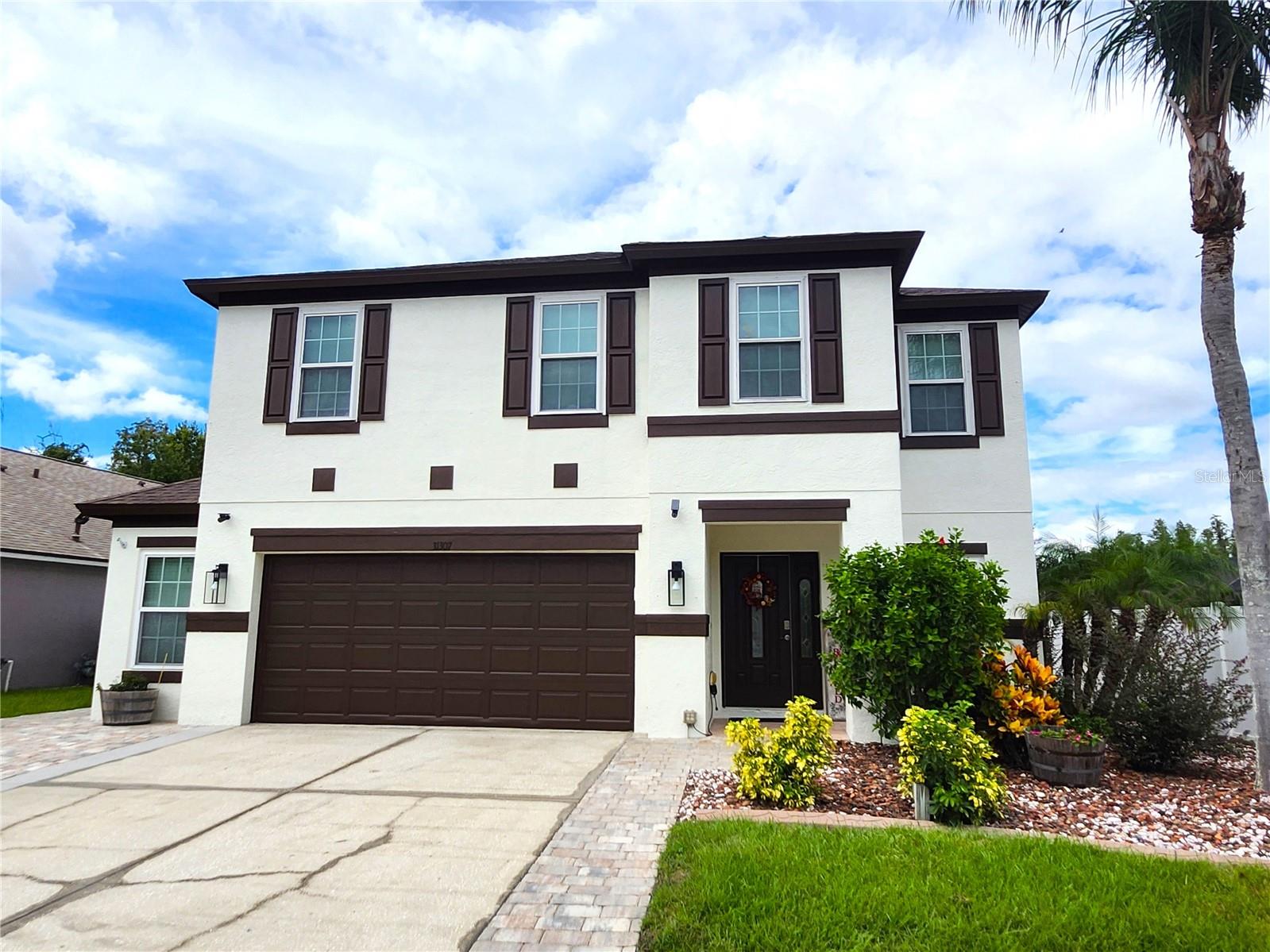 Welcome to this gorgeously updated, Ready-to-Move-In 5 bedroom + loft home with its own resort stye pool in Pasco County’s highly desirable Meadow Pointe neighborhood. Fully fenced yard with thick woods behind, this extra-long homesite offers more than ample room in and beyond the pool area. Perfect for entertaining, the entire 45’X32’ pool area is covered with luxurious pavers, where you’ll find a 10’X10’ gazebo and a shallow splash pad/tanning area. The gourmet kitchen has been totally remodeled with stone counters, 5’X8’ island with underneath storage, single bowl SS sink with touchless faucet, Stainless Steel appliances (natural gas), 42” white kitchen cabinets, and all new light fixtures. The entire first floor reveals hardy luxury vinyl plank while engineered hardwood is found on the stairs and master bedroom. The primary bath has also been renovated with a doorless shower, free standing soaker tub, double sink vanity, backlight mirrors, and luxury vinyl flooring. Take comfort knowing all major home components have already been addressed including Triple Pane Windows throughout (2016), Roof (2019), Both A/C units (2017), Gas water heater (2023), exterior painted (2024), pool resurfaced with Pebble Tec (2020), and a new pool pump (2025). The 2.5 car garage has been enhanced with extra storage including hanging shelving, and the driveway has been widened to over 26 ft, easily accommodating 3 cars across. The screened lanai has been extended across the entire back of the home with a built-in 40sf shed at the end. The stackable washer and dryer, wall-mount TV in nursery and loft, and the playground equipment on rubber mulch all convey with the home! This tastefully updated and thoughtfully enhanced home is in a highly rated school system and is close to Meadow Pointe III’s amenity center which includes a clubhouse, gym, tennis/basketball/volleyball courts, and pool. This home’s location in the gated village of Wrencrest allows direct and convenient access to Meadow Pointe Blvd, a direct route to SR 56. Call today for your private tour!