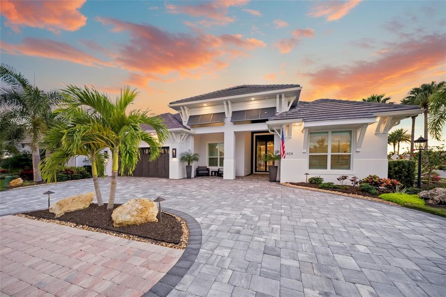 Nestled in the heart of Bradenton’s most coveted enclave, this custom-built masterpiece redefines luxury living. This custom home spares no detail, offering 3,873 square feet of pure sophistication with 4 bedrooms, 3 full baths, 2 half baths, and a versatile bonus room. Tandem space in the oversized garage allows space for a golf cart and storage.  Every inch of this residence has been thoughtfully designed to blend elegance, comfort, and functionality. All windows and doors in the home are impact glass and it is equipped with a whole house Generac generator.

From the moment you arrive, the home’s striking presence is undeniable. A grand 13’5” iron front door with privacy glass welcomes you into a world of refined craftsmanship. Inside, premium finishes abound—level 5 flooring, engineered hardwood with wide tongue-and-groove planks, custom wood built-ins illuminated by LED lighting highlighting a 100” linear electric fireplace and a dry bar equipped with a Sub-Zero beverage cooler all exude timeless luxury. Smart home technology and a whole-home Generac generator add modern convenience and peace of mind.

At the heart of the home lies a chef’s kitchen that dreams are made of. Outfitted with level 10 custom cabinetry, a show-stopping 54” wood hood, and high-end appliances—including a Sub-Zero double-door refrigerator, Viking 7 Series range with double ovens, and a 102-bottle Sub-Zero wine fridge—this space is both stunning and functional. The walk-in pantry, complete with an office nook, and a handcrafted Native Trails sink elevate the kitchen to a whole new level.

Step outside to your private oasis, where over 2,000 square feet of lanai space beckon for relaxation and entertaining. A fireplace, custom beams, and a tongue-and-groove ceiling set the tone, while the oversized 20’x37’ pool with Shell-lock flooring pavers provides a serene retreat. This outdoor haven is as functional as it is beautiful, perfect for hosting gatherings or enjoying quiet evenings under the stars.

The spa-inspired master suite is a sanctuary of comfort and style. Imagine unwinding in the rain shower with digital controls accessible via iPhone, soaking in the Native Trails tub, or enjoying the sleek floating cabinetry with under-cabinet lighting. The custom-designed walk-in closet is a statement piece, offering unparalleled organization and storage.
Practicality meets luxury with additional features like dual AC units in the home for optimal efficiency, and a split AC system in the garage along with custom storage cabinetry. Situated on a North-South facing corner lot, this home offers both privacy and an ideal layout to maximize natural light.
Located in Country Club East in Lakewood Ranch, residents enjoy a resort-inspired lifestyle surrounded by scenic beauty and sophistication. Three community pools—including The Retreat, a centerpiece of leisure—offer endless opportunities for relaxation and recreation, complete with a resort-style pool, state-of-the-art fitness center, inviting social spaces, outdoor kitchen, and picturesque nature trails, all included with HOA fees.
For those seeking an even more elevated experience, optional memberships at the Lakewood Ranch Golf and Country Club provide access to world-class golf courses and exclusive social amenities. Ideally situated near lively town centers, year round events, premier shopping, dining, miles of walking trails cultural attractions, and world-renowned Gulf beaches.