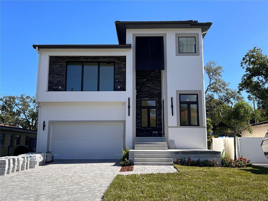 One or more photo(s) has been virtually staged. Under Construction. Near completion, this luxury residence offers a dynamic layout, top-of-the-line finishes, and a private oasis in the heart of Davis Islands. Attention to detail and craftsmanship are evident throughout this quality custom home built by Summit Bay Construction, whose experience and customer satisfaction speak for themselves. Their commitment to excellence is reflected in their achievements, as Summit Bay is proudly celebrating its fourth consecutive Parade of Homes Grand Award. Known for personalised service, integrity, and quality, Summit Bay delivers only the finest in custom home building. An elegant entry tower with chandelier welcomes you inside. Upon entry, you’ll find a private front office and powder room. The great room features an open-concept design with 12-foot ceilings and overlooks the large patio and outdoor kitchen. The dining and living area includes a dry bar buffet with wine and beverage refrigerators, perfect for large gatherings and catered events. The gourmet kitchen, overlooking the living room, showcases quartz countertops, top-tier stainless steel appliances, and copious custom cabinetry and storage. Appliances include a Thermador 48” Gas Range Cooktop with Griddle, Thermador 30” Double Built-In Oven, Thermador 48” (26.8 cu. ft.) Built-In French Door Refrigerator/Freezer, Bosch Dishwasher, and Thermador under-counter microwave. The kitchen also features a walk-in pantry and an abundance of storage. A first-floor bedroom with en suite full bath provides convenience and privacy for guests. The home also includes an electronics room and Wi-Fi boosters throughout, plus wiring for a security system, cameras, and TVs. The mezzanine level, accessed through a hidden-entry Murphy door, offers a bedroom or flex space with a large balcony, ideal for a guest suite, office, or private lounge. The second level, featuring 10-foot ceilings, hosts a spacious primary bedroom with a beautiful bathroom retreat, two walk-in closets, and a rain shower. A separate primary lounge area is prepped for a coffee machine and under-counter refrigerator, making it the perfect morning or evening retreat. Enjoy your private balcony off the primary suite—ideal for morning coffee or an evening cocktail. This is truly a grand primary retreat, allowing complete privacy without the need to go downstairs.
The second level also includes three additional bedrooms, each with private bathrooms featuring premium tiles and fixtures. The home boasts an abundance of storage and closets, including an accessible storage loft. An oversized two-car garage offers side-entry golf cart access and an option for a car lift, perfect for car enthusiasts. The home is wired for a 26KW emergency gas generator. The backyard oasis features tropical landscaping, a plunge pool with waterfall and sun shelf, and a fully equipped outdoor kitchen with Bull gas grill, Zephyr hood, and two-drawer under-counter refrigerator. Built to the highest standards, this home includes a tankless gas water heater, standing seam metal roof, impact-rated PGT casement windows and doors, premium flooring, paver driveway, front patio and balcony, Kohler and Toto plumbing fixtures, Visual Comfort lighting fixtures and chandeliers, dual-zone air conditioning, and premium cabinetry throughout.
Bring your golf cart and enjoy the Davis Islands lifestyle, with charming local restaurants and shops just minutes away.