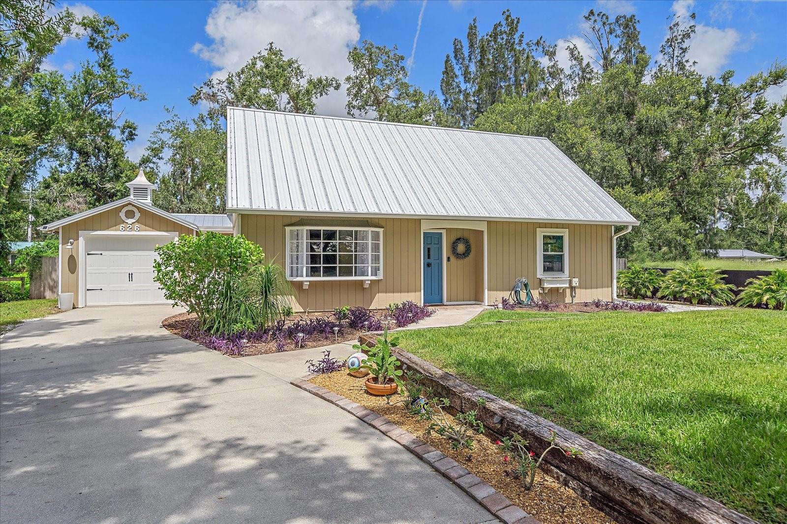 Run don't walk to see the charming and completely updated home on nearly a 1/4 acre. This home has 2 bathrooms and 2 bedrooms with a flex room that could be easily converted to a third bedroom. Beautifully remodeled from top to bottom. No expense was spared to bring this home up to like new status. Here's a list of the new items: hurricane impact windows, metal roof, septic system, all electrical breakers and shut offs for AC, whole home surge protectors, ceiling fans, all door and cabinet hardware, gutters and gutter guards, speakers in ceiling, recessed lighting, well pumps with pressure switch, mini split in upstairs flex room, insulated garage door, underground electrical service. Alarm and camera system to keep and eye on things no matter where you are.  No HOA so you can bring your toys and work vehicles. There's plenty of room to park them and still be able to access the garage. The large 21 X 18 shop is equipped with electric making a great place for storage, hobbies or convert to a mancave. The backyard is shaded and fenced perfect for entertaining and relaxing around the paver deck with fire pit. Super convenient to shopping, grocery, hardware, restaurants, everything you need. The beaches and downtown are only a 30 minute drive away. Are you running yet? Come see it today!