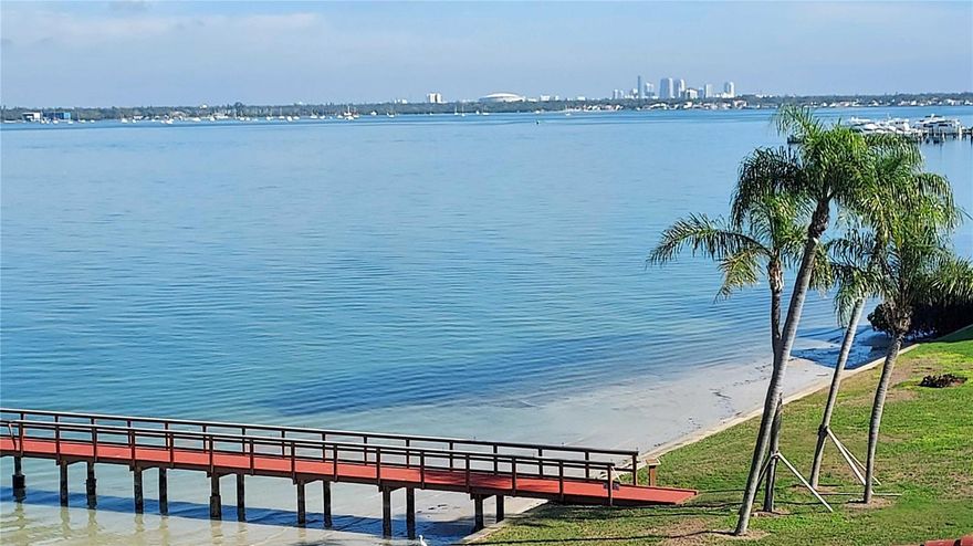 Whether you are looking for your new home or want to own a vacation rental, this move in ready condo is just what you need. Imagine sweeping water views of Boca Ciega Bay. Enjoy your morning coffee on the tiled balcony while watching the sun rise over St. Petersburg or perhaps an evening cocktail as the sun sets into the Gulf over St. Pete Beach. Located on the 4th floor, this 1 bedroom / 1-1/2 bath condo was completely renovated, from ceiling to floor, in 2018. The well-appointed kitchen features quartz countertops, a built-in ceran cooktop and 40” high kitchen cabinets. The spacious living and dining area are perfect for entertaining. The oversized bedroom offers an ensuite bathroom with both a linen closet and walk-in closet. There is plenty of additional storage available from the wall length wardrobe closet to the  unique under mattress storage bed. Even the sleeper sofa has a hidden storage feature. Feel secure knowing there are high impact windows and sliding glass doors throughout. Along with the brand-new AC and water heater that were installed in September 2025, and the all-in-one washer dryer combo, this condo’s energy efficiency is optimized. Outside your living quarters you will find plenty of activities to choose from. The complex offers a clubhouse with a fitness corner, TV, books and free Wi-Fi. You’ll also find a heated/chilled pool and hot tub located directly on the waterfront.  Relax in the sun while watching the dolphins frolic in the bay or fish from the nearby dock. The building itself is in top condition. It was freshly painted in 2024, and a new roof was placed in 2025. The condo has one assigned, outside parking space. If needed, an extra covered space may be available to rent from the association. It also has an assigned storage space in the building. Casa Del Mar is located amidst the first-class golf course at Isla Del Sol Yacht & Country Club. You can walk to restaurants and shops nearby and are just a bridge away from Fort Desoto Park or St Pete Beach. Head to downtown St Pete to enjoy the nightlife and culture and even more restaurants and shops. There is everything you need to live the true Florida lifestyle!