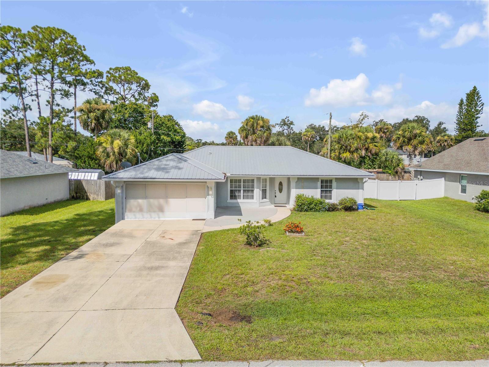 Welcome to Your Florida Shores Retreat and step into this beautifully maintained, like-new home built in 2005, now ready for its second owner. Designed for comfort and functionality, the open-concept layout features a split floor plan with three spacious bedrooms, two full baths, and a versatile family room — offering plenty of space for everyone to gather or spread out.
Built with quality in mind, this concrete block home boasts a durable metal roof, two car garage and a whole-house gas generator, giving you peace of mind in any season. The fully fenced backyard creates a private outdoor oasis, perfect for relaxing, entertaining, or letting pets play freely.
Ideally located just 10 minutes from New Smyrna’s pristine beaches, you’ll also enjoy easy access to charming shops, local dining, excellent schools, grocery stores, and public parks — all just around the corner.
Move-in ready and offered at an incredible value, this home blends convenience, durability, and coastal living. Schedule your private tour today — at this price, it won’t last long!