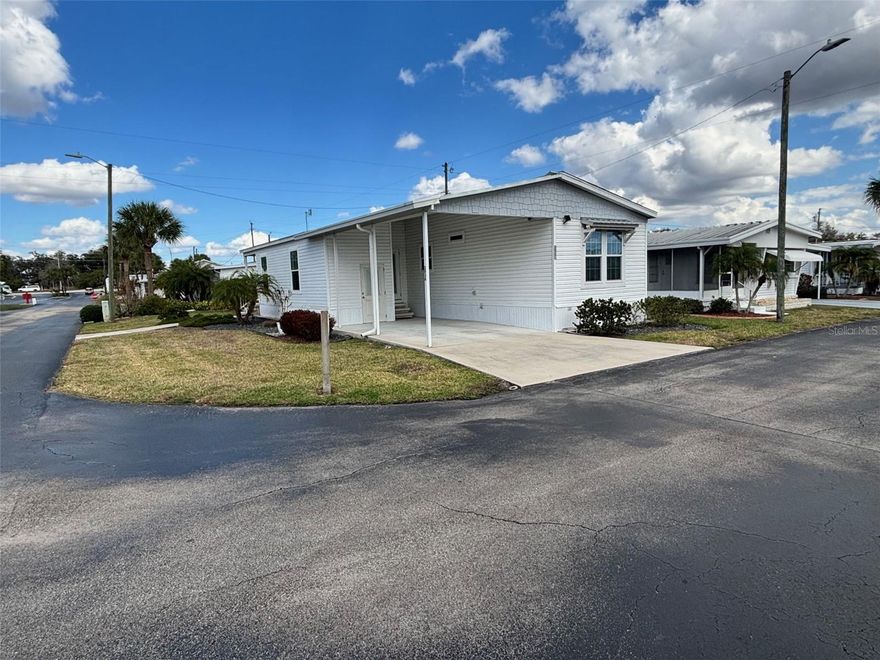 THIS IS A MANUFACTURED HOME ON RENTED LAND IN A PARK. SOME OF THE AUTO-POPULATED DATA PERTAINING TO THE UNDERLYING REAL PROPERTY MAY NOT BE APPLICABLE.   
Lovely, late model (2020) doublewide in immaculate condition, in Leisure Acres and ready for YOU! Home is catty corner from the recreation center, and this park has more amenities than you can shake a stick at: Well-appointed, enormous Clubhouse. Heated pool with free Wi-Fi. 40-acre nature preserve. Billiards room. Shuffleboard courts. Cornhole. Horseshoe pits. Chipping green. Ponds with fish cleaning station. RV and boat storage area. Well-equipped fitness center. Library. Hobby room. Home is almost entirely furnished including quality leather living room furniture, cedar-lined bedroom dresser, silverware and high-quality kitchen utensils. Immaculate, top-quality, late model appliances. Like-new combo washer/dryer unit and tons of storage. Large, lockable utility room. Equipped with ADT security system. Friendly neighbors and park management. $549/month lot rent is substantially less expensive than comparable parks, and includes water, sewer, 2x/week garbage removal and lawn mowing, in addition to the lovely common areas and amenities. Park is directly on U.S. Highway 27 with easy access to restaurants and grocery stores, but this unit is in quiet area not far from 40 acres of nature preserve. Home has a lovely, covered back porch accessible via French doors with internal blinds from both the living room and master bedroom, with its own sidewalk to the street, and appears to be the only home in the vicinity with that upgrade.