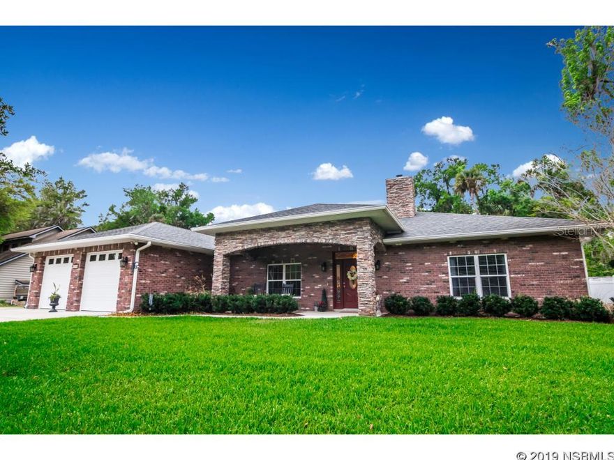 Beautiful New Smyrna Beach home located in desirable Corbin Park located within minutes to beach.  Custom built home with brick and stone exterior, impact windows, oversized garage for full sized truck, 2 A/C units, insulation in all interior walls, and much more.  Step inside this inviting home through the foyer and enter the great room with vaulted ceiling, hard wood floors, wood cabinets, granite counter tops, pantry, stainless appliances, including double oven and sink in island.  The split floor plan offers plenty of privacy for guest and master suite.  Extra large guest bedrooms and bathroom are separated by a hall with barn door.  The spacious master suite is equipped with large walk in closet that has custom built cabinetry, a sitting room separated by French doors, and lovely master bath that has jetted tub, walk in shower with two shower heads, his and her vanities and enclosed water closet. Laundry/mud room has ample cabinetry and extra storage in loft area. Both the front and back of house have covered porches. Back yard is fenced with paver pergola area and small storage shed. Bring the boat or RV and park it on the concrete pad next to garage. This home offers so many extras that just have to be seen in person. ;Water: City