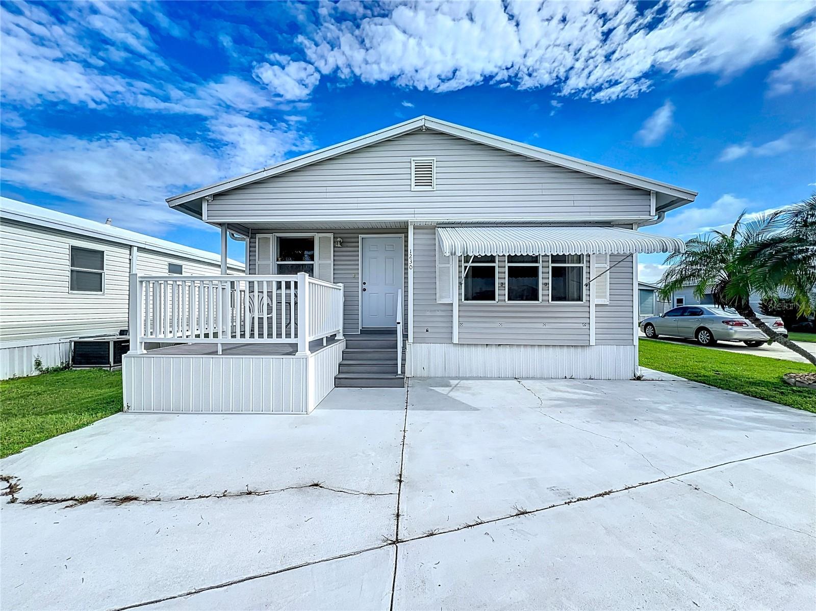 BRING YOUR OFFER ON THIS CHARMING MOBILE HOME IN AN ACTIVE 55+ COMMUNITY. This home features a comfortable living room with newer furniture, a spacious dining room, and primary bedroom with two large closets. 1 1/2 baths. The main bathroom has tub/shower combo. The second bedroom also has laundry and an en suite half bath. Appliances included. Well kept and sold turn-key. Paved patio area behind the home and a front deck with composite deck boards. Metal roofover, central A/C (2019). Sugar Creek Country Club has NO LOT RENT and low fees of just $525/quarter. Fees include water, sewer, trash, grass mowing, internet, & basic cable. The community features two swimming pools, heated spa, tennis & shuffleboard courts, workshop, fitness room, clubhouse, fishing pier, and many social activities through the winter season. Sold for CASH ONLY with right to inspect. Sorry this is not a pet lot. Don't let another winter keep you in the cold--start enjoying Florida today!