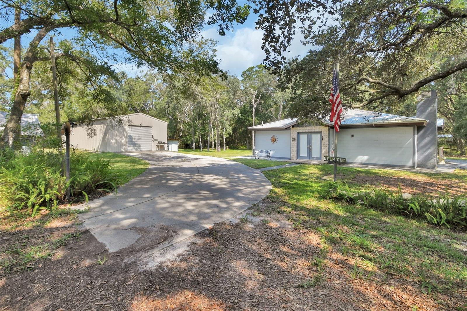 This unique property offers space, versatility, and opportunity. Property includes 2.77 acre corner lot. There are two parcel numbers on this home and addresses- 445 Azalea 6039-10-00-0080 and 3640 Coral 6039-10-18-0150. Both parcel numbers being sold together. The main home is a simple but well-kept 1-bedroom, 2-bath residence, (Original blueprints called for two bedrooms - but kept the wall out and opened up for more living area ), Recently updated with a brand-new AC (2025), metal roof and an updated septic and drain field, so you can move in with peace of mind. There is a fireplace, but they covered it up for their needs but could be opened back up.
The star of the property is the 24x60 METAL BUILDING with power, insulation, and water, perfect for storage, a workshop, garage for multiple cars or business use. You’ll also find multiple additional storage options, including an 8x40 shipping container used for storage, pump house, chicken coup, and several other outbuildings. Off the home is a neat party room ready for your barbecue and relaxing.
For added flexibility, the barn was partially converted into a small APARTMENT years ago with a bedroom and bathroom - but has been used for storage for years—ready for renovation to fit your vision. The property also features two wells and a gas generator for backup power.
With 2.7 acres of land, you’ll have room to spread out and create the lifestyle you want—whether that’s a hobby farm, workshop space, or simply a private retreat.