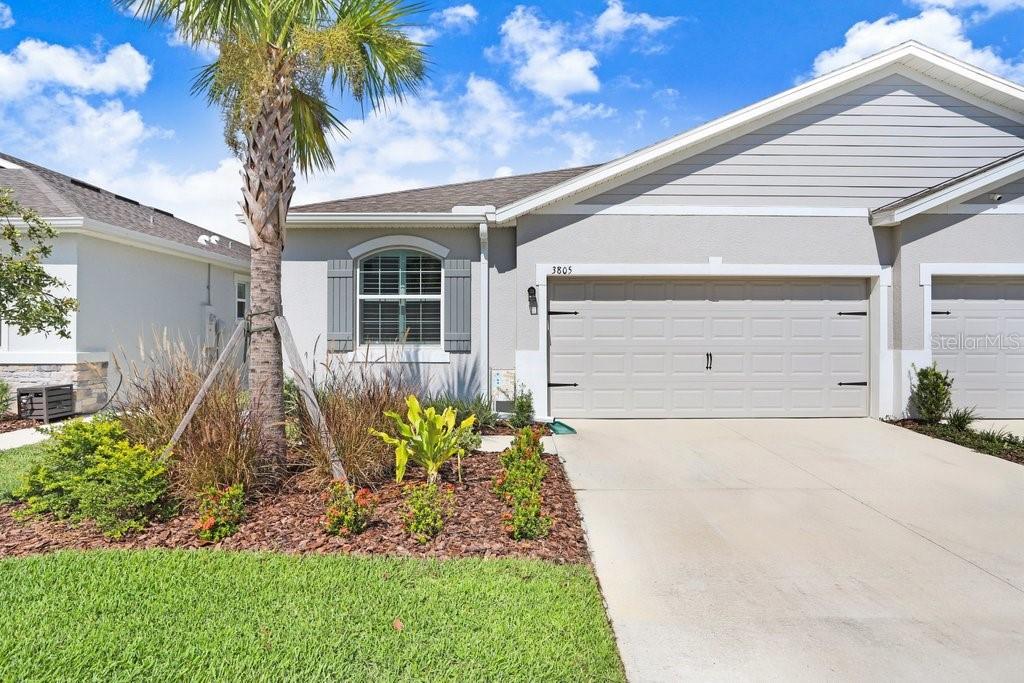 SO MANY UPGRADES! This beautiful 3 bedroom/2 bath Villa is located in the new and upcoming community of Farm at Varrea. The upgrades include, but not limited to, Plantation Shutters; Light Gray Tile throughout; White Cabinets; Granite Countertops throughout; Under Cabinet Lighting; Beautiful Subway Tile Backsplash; Epoxy Flooring in Garage, Back Patio, and Front Door Landing; Screened Back Patio with Sun Shades; Extra insulation blown in Attic; Insulation in the Garage Door; Water Filtration System installed; All Large Kitchen Appliances are included; Washer and Dryer is also included. The Community offers two pools; a Park; a Playground; a Workout Center; a Dog Park; an Area that you can sit by pond that is covered and has rocking chairs; and plenty of Walking Trails throughout. Golf carts are allowed. You have to see this home to truly see the beauty of it. The home has a split bedroom plan. The colors make the home look very crisp, fresh and clean. Your backyard has a beautiful view of a conservation area with trees and the walking trails.