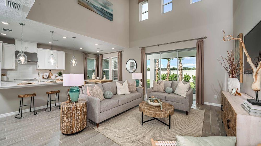 New Construction – Ready Now! Built by Taylor Morrison, America's Most Trusted Homebuilder. Welcome to the Bahama at 8566 Big Dipper Drive in Cassia at Skye Ranch. This charming two-story home blends traditional elegance with everyday comfort. Downstairs, the open-concept layout brings together the kitchen, casual dining area, and great room beneath a soaring two-story ceiling—perfect for cozy evenings or lively gatherings. The designer kitchen features a spacious island and walk-in pantry, with easy access to the formal dining room just off the foyer. The downstairs primary suite offers a peaceful retreat with a large bedroom, generous walk-in closet, and a stylish bath complete with dual sinks, a private commode, and an oversized shower. Prefer a spa-like escape? Choose the deluxe bath option with a garden tub and separate shower. Step outside to the sunny lanai that spans the back of the home—ideal for relaxing or entertaining. Add the optional outdoor kitchen to make alfresco dining a breeze. Upstairs, a bright loft overlooks the great room below and leads to a tucked-away study. Three additional bedrooms are located on the second floor—one with its own private bath, while the other two share a thoughtfully designed bathroom. Additional Highlights include: 42" upper kitchen cabinets, upgraded cabinets in bathrooms, upgraded kitchen/bathroom quartz counters and Mohawk flooring, gourmet kitchen, shower only in bathroom 2, outdoor kitchen rough ins, pre plumb for laundry sink, and 8' interior doors. MLS#A4664284