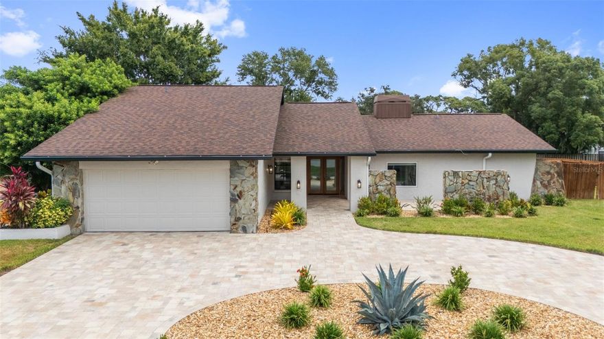 STOP THE CAR!!!!  NO FLOOD INSURANCE REQUIRED!!  ZONED PALM HARBOR UNIVERSITY HIGH SCHOOL. Gorgeous, BLOCK CONSTRUCTION, 4 Bedroom, 2 Bathroom, 2 Car Garage, POOL HOME located in the very desirable Palm Harbor neighborhood of "Eniswood". Pride of Ownership is obvious as you pull up to this BEAUTIFULLY LANDSCAPED property with NEWER PAVERED, CIRCULAR DRIVEWAY (2023).  Enter through the DOUBLE DOOR ENTRY and be prepared to be wowed!! This home has so many features including... NEWER ROOF 2020, ENTIRE EXTERIOR PAINTED (2025) WITH NEW GUTTERS! (2025), UPDATED AIR CONDITIONING PRIMARY SIDE 2023, NEWER VINYL FLOORING 2022, GRANITE KITCHEN with WOOD CABINETS and STAINLESS STEEL APPLIANCES; SPLIT BEDROOM FLOOR PLAN; UPDATED SECOND BATHROOM with DOUBLE VANITY; SPACIOUS PRIMARY SUITE with LARGE WALK-IN CLOSET, BATHROOM with DOUBLE VANITY and sliding doors to the pool area; Large FAMILY ROOM with DOUBLE SIDED FIREPLACE and VAULTED CEILINGS, INTERIOR LAUNDRY/UTILITY ROOM, OVERSIZED 2-CAR GARAGE, WITH NEW OPENER (2025), SCREEN-ENCLOSED IN-GROUND RESURFACED POOL (2019) and a HUGE FENCED IN BACK and SIDE YARD (2023) with 1,365 SF of NEW OUTSIDE TURF (2024) along with a NEW IRRIGATION SYSTEM (2023) for the entire family!! ENERGY EFFICIENCY UPGRADE WITH BLOWN-IN INSULATION THROUGH THE ENTIRE HOUSE (2024)! Located at a HIGH ELEVATION, this home is NON-FLOOD and zoned for Palm Harbor High School. Close to restaurants, shops, hospital and a short commute to the Bay Area beaches and two International Airports, this home is a MUST SEE!!!