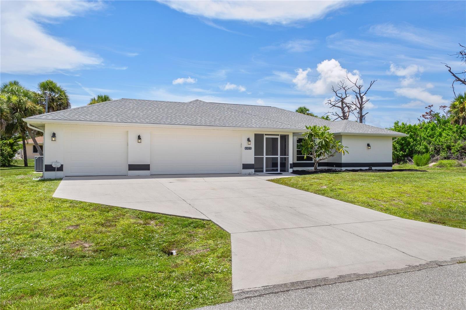 One or more photo(s) has been virtually staged. Get ready for the good life! This 3 bed, 2 bath, 2,089 square foot home built in 1994 has an oversized .34 acre lot. It boasts NO HOA and NO Deed Restrictions. Enjoy putting your toys away in a massive 3-car garage with almost new hurricane grade doors. Relax in your gorgeous, large, caged-in pool that is newly resurfaced. X FLOOD ZONE and NO hurricane damage or flooding ever. 30-year shingle/2015 roof, 2015 A/C, 2015 Water Heater, massive kitchen with a pass-thru window to the pool deck, separate family room, private outdoor shower. Walk- in closets for every bedroom. Newly painted inside and out. This home was built to last with premium construction techniques. Continuous pour concrete, insulated block, and tie beam. Close to Gasparilla Rd. and beautiful Boca Grande, and an easy drive to Englewood Beach. Just a mile to The Cove Golf Course, and 2 miles to Home Depot and Publix. Great opportunity to build equity in your slice of paradise. This home has great bones, and loads of potential.
