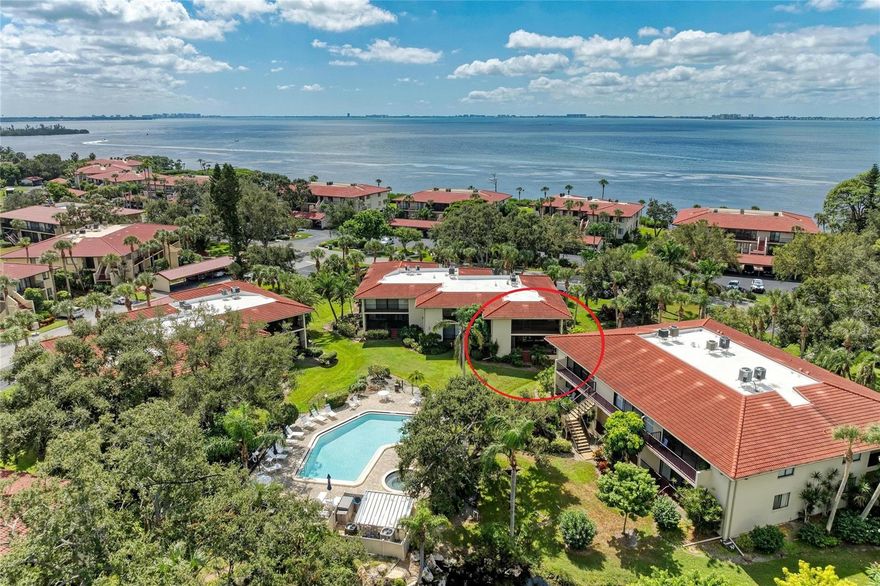 Enjoy tranquil views of Sarasota Bay from the kitchen and front porch, along with pond views from the screened lanai. This first-floor end-unit condominium is located in the Wild Oak Bay community, featuring mature landscaping, lagoons, botanical surroundings, and canopying oak trees. Conveniently situated near IMG Academy and approximately one mile from the IMG Golf & Country Club. Residents enjoy proximity to beaches, Sarasota-Bradenton International Airport, and downtown Sarasota’s shopping, dining, and cultural attractions. The private lanai offers a peaceful garden and water view, with opportunities to observe a variety of local wildlife including pelicans, herons, eagles, turtles, and otters. Nearby shopping and daily conveniences are also close by.