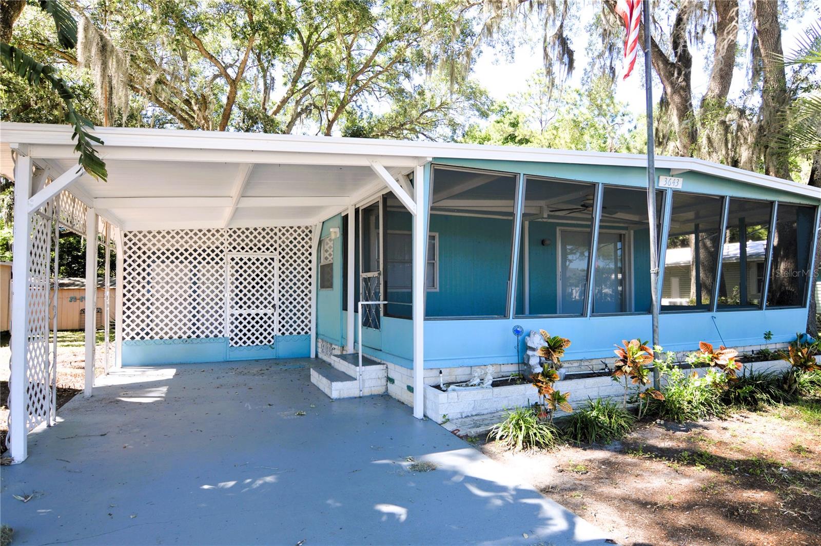 !! 10% PRICE REDUCTION !! AFFORDABLE FLORIDA RETIREMENT LIVING!! OWN YOUR OWN LOT with no lot rent in this active 55+ adult community located minutes from Zephyrhills and a short drive away from Lakeland or Tampa. This doublewide mobile home has been updated with laminate flooring and tile flooring in each bathroom and kitchen. 2bed/1.5 bath floor plan is open and feels much larger than it is. Sliding glass doors lead out to a large 10'x23' screened front porch. Plus there is an additional 11'x16' screen enclosed porch under the carport. Laundry and storage room offers storage shelving and washer/ dryer hookups. Roof has been updated with a membrane type roof. Also included in the sale are 3 detached storage sheds in the rear yard. Community amenities include shuffleboard, clubhouse, pool, sidewalks, and streetlights. Possible owner financing available.