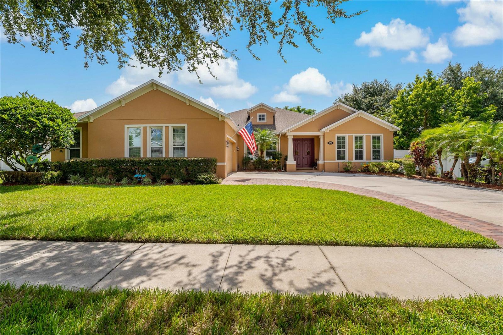 A MUST SEE! Beautifully maintained 4-bedroom, 3-bath POOL home with an office/den, perfectly situated on a corner lot nestled in the Estates of Auburndale! A gated community offering an abundance of amenities - including a playground, dog park, basketball court, a community pool, and a walking trail. Spanning over 2,500 square feet, this home boasts a bright and airy OPEN FLOOR PLAN that seamlessly connects to the kitchen, featuring GORGEOUS countertops, a lovely backsplash, ample cabinets for storage, and a LARGE island. Ceramic tile flows throughout the entire home for a clean, modern look and easy maintenance. The primary bedroom is complete with a WALK IN closet and EN SUITE bathroom that has it all - TWO separate vanities, a garden tub, and a step-in shower! LUSHLY LANDSCAPED and a variety of mature fruit trees that will stay with the home—papaya, mango, guava, banana, avocado, olive, and even a pineapple plant! Step outside to your PRIVATE oasis, provided by a fully fenced backyard, a saltwater pool with screen enclosure, and a LARGE PATIO space, perfect for relaxing or entertaining. Don't miss the chance to own your DREAM HOME. Call us TODAY!