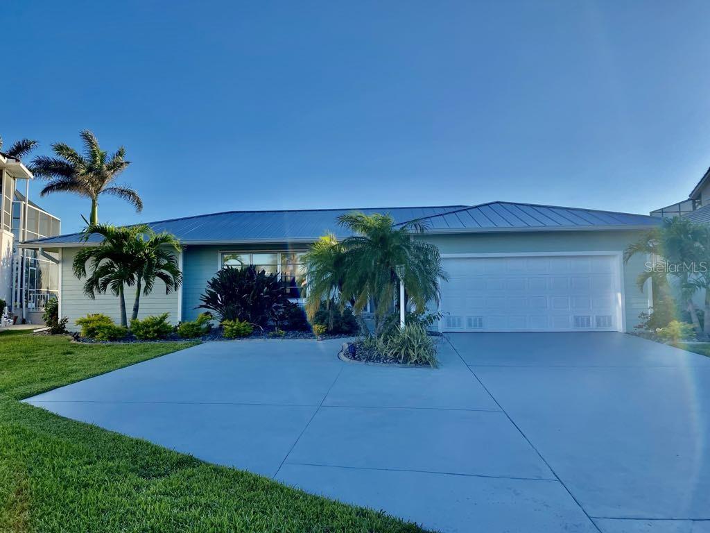 LOCATION, LOCATION, LOCATION. Spectacular views from this 3/2/2 in deed restricted Punta Gorda Isles. 95’ of frontage on Sea Trout Strait revealing intersecting canals and a large turning basin. This is a deep sailboat waterway with no bridges and fast access to Charlotte Harbor and beyond. Lounge in your pool while watching the boats go by. The annual Christmas boat parade ends at your back door. Private heavy duty boat lift and concrete dock included. New metal roof in 2025, new HVAC system in 2021, new stucco lap siding in 2021, updated landscaping in 2021 and updated guest bathroom. Notice the fantastic layout with the family room open to the kitchen. Also has a sunken living room. The master suite has a large walk-in closet and full bath. No water intrusion into the home from any hurricane. House is surrounded by million dollar homes.