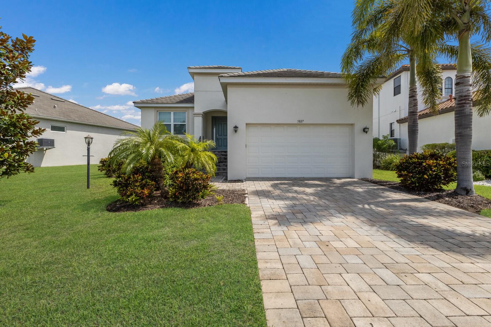 Welcome to this exquisite St. Thomas model by Medallion Home, nestled in the highly desirable Legends Bay gated community! Constructed in 2018, this spacious residence features 3 bedrooms, 2 bathrooms, and a den, offering 2,162 heated square feet of comfortable living space. Enjoy breathtaking lake views and spectacular sunrises from the screened lanai, plus a brand new 2025 built-in ground pool. The open floor plan showcases high ceilings, 8-foot doors, and elegant ceramic tile flooring throughout.
This home is equipped with hurricane-impact windows, a durable tile roof, and upgraded fans and light fixtures. Located in a maintenance-free community, residents can indulge in resort-style amenities, including a dock with views of Sarasota Bay, a clubhouse, and a refreshing pool. Plus, flood insurance is not required on the assumable mortgage! Conveniently situated near Anna Maria Island, this home is a true gem.