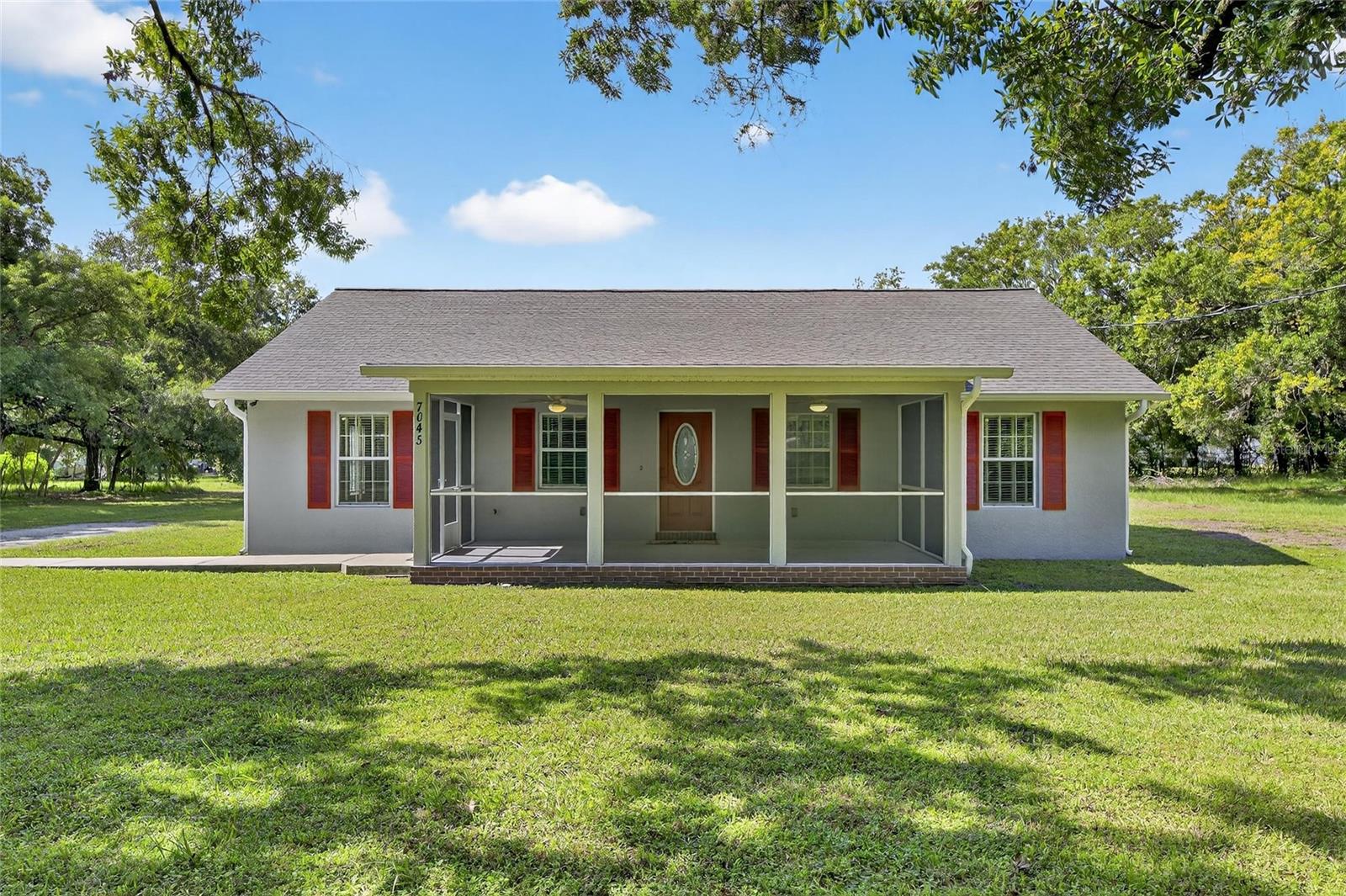 **Modern Comfort Meets Country Charm on Nearly an Acre**
Welcome to your peaceful retreat in Dover! Nestled on a spacious **.85-acre lot**, this beautifully maintained 3-bedroom, 2-bathroom home offers the perfect blend of function, comfort, and thoughtful design.
Step inside to a bright and open floor plan with a **spacious living room** and a **well-appointed kitchen** featuring 42” wood cabinetry with soft-close drawers, **granite countertops**, **stainless steel appliances**, and ample counter and storage space—ideal for any home chef.
The **split bedroom layout** provides maximum privacy, with the **primary suite** boasting a **zero-entry shower**, granite-topped dual vanity, tall storage cabinet, and a **walk-in closet**. The **guest bedrooms and bath** are located on the opposite side of the home and can be closed off from the main living area to create a true **guest suite**. The generously sized guest bathroom is ADA-friendly and features a tub/shower combo with granite counters and wood cabinetry.
Additional highlights include:
* **Interior laundry room** with upper cabinets and utility sink
* **Fresh interior and exterior paint**
* **Re-screened front porch (Aug 2025)**
* **New water softener and well equipment (2025)**
* **Double-pane windows** for energy efficiency
Enjoy room to breathe, no HOA, and the freedom to live how you want—all while being just a short drive to nearby amenities and I-4.